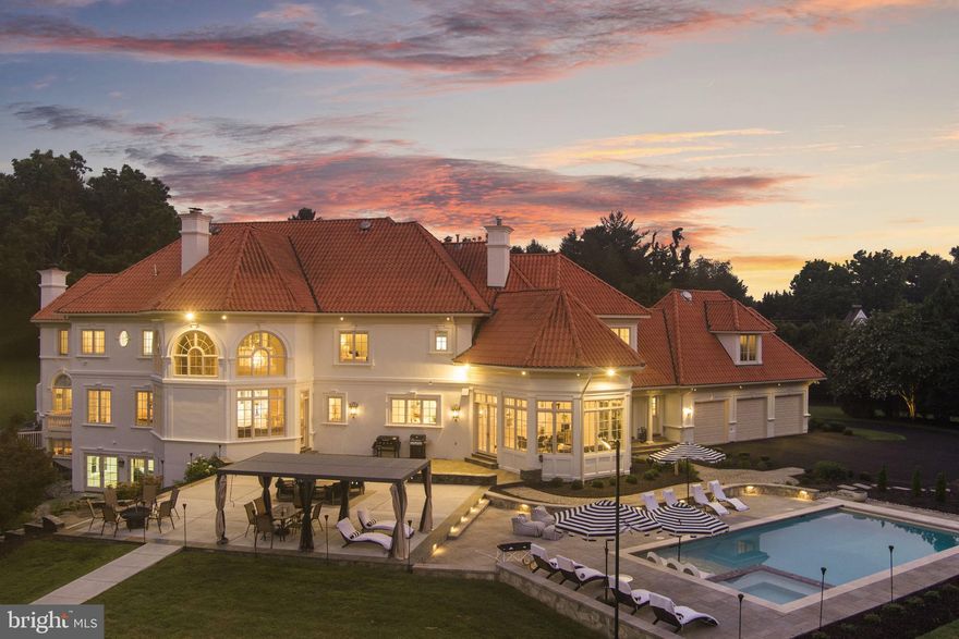 Welcome to an exceptional private estate offering resort style living in the heart of Great Falls! Set behind secure gates on more than five and a half acres, this Mediterranean inspired residence has been completely transformed with extensive brand new upgrades throughout, creating a turnkey luxury retreat ready for immediate enjoyment.
The home spans over 12,000 square feet of newly updated living space designed for both everyday comfort and large scale entertaining. The open and airy floor plan flows effortlessly, ideal for multigenerational living and elegant gatherings. Every major system and finish has been thoughtfully replaced or upgraded, delivering the peace of mind that comes with essentially new construction. 
At the center of the home is a massive, yet cozy family room, drenched in daylight with floor to ceiling windows, a soaring stone fireplace extending to the ceiling that serves as a stunning statement piece, and a completely brand new chefs kitchen equipped with top tier Miele appliances, a cafe style gas range, quartz countertops, and custom cabinetry. This space is designed to impress while remaining highly functional for daily use and entertaining.
Also on the main level is a one of the two primary suites, a grand formal dinning room, an elegant formal living room, along with a beautifully renovated sunroom filled with natural light that creates the perfect space for morning coffee, reading, or relaxing year round. 
And lastly, a brand new laundry and mudroom, thoughtfully designed with custom cabinetry, modern finishes, and functional storage.

The upper level features a second expansive primary suite, along with four additional en suite bedrooms, all offering walk in closets and beautifully redesigned bathrooms. Each bath showcases brand new designer finishes including full slab marble showers, custom vanities, and modern fixtures inspired by luxury spa living.

The walk out lower level offers a versatile entertainment experience with a private home theater, a large home gym that can easily be converted to a 7th bedroom, a full bath, expansive recreation space and tons of storage. 

Outdoor living is equally impressive with a heated saltwater pool, newly constructed basketball court, a pond, extensive new hardscaping, and a flagstone patio ideal for outdoor dining and gatherings.
The circular driveway provides ample parking for over 25 vehicles in addition to the three car garage, making entertaining effortless. 
Major improvements include six new HVAC systems, new roof insulation, a newly paved driveway, and a newly added  generator installed in 2026.
This is a rare opportunity to own a fully updated luxury estate where nearly everything is brand new. A true destination property offering privacy, sophistication, and resort level amenities in one of Great Falls most prestigious settings.
Enjoy prime Great Falls location,  with just minutes to Tyson's corner, Route 7, and 495! And just  0.7 miles from Great Falls Village, home to popular restaurants and coffee shops, grocery shopping and other shops for everyday convenience.
Schedule a tour today to fully appreciate the craftsmanship, scale, and setting of this remarkable home!
Square footage information is deemed reliable but not guaranteed.