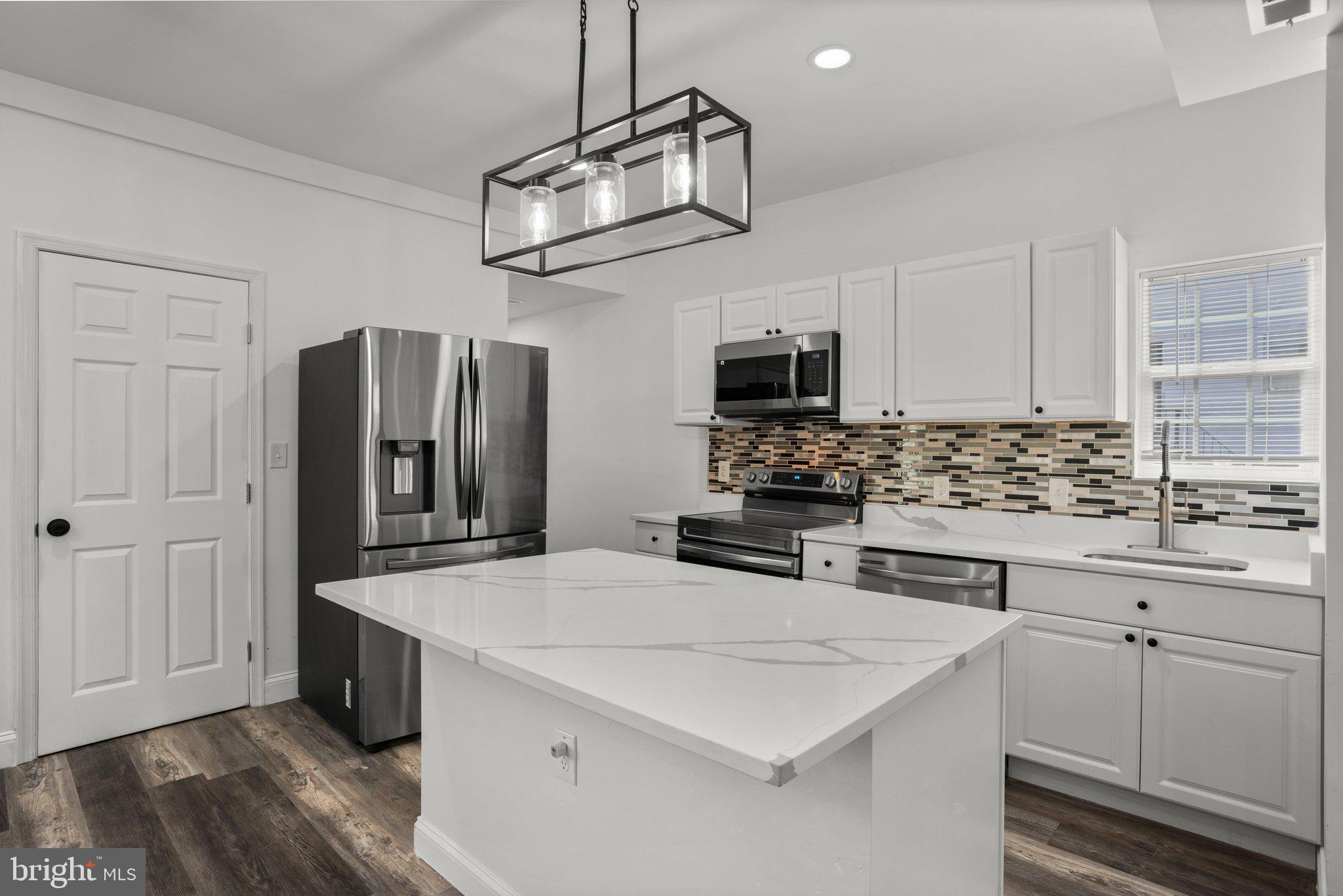 OPEN HOUSE SUNDAY MAY 18, 11am - 1 pm . Fully remodeled! Welcome to luxury living in Baltimore. Step into a beautifully renovated 5-bedroom 4-bath home in Baltimore, where every detail has been meticulously crafted for modern living. This home has been upgraded from top to bottom, with all necessary permits pulled for the installation of new electrical systems, plumbing, and HVAC. With its inviting porch front, this charming residence boasts 5 spacious bedrooms and 4 bathrooms, including a master suite on the second floor with a combination of a stunning freestanding tub and a separate shower which is perfect for unwinding in style. Kitchen is stacked with high-end fixtures, energy-efficient appliances, and an open floor plan to create an atmosphere of luxury and comfort. The chef-inspired kitchen features stainless steel appliances, sleek quartz countertops, a 5-burner electric stove with an over-the-range microwave, a custom backsplash, and an energy-efficient Samsung refrigerator. The main level offers a generously sized living and dining area, a powder room, and an exterior door leading to a private deck. Upstairs, you'll find three large bedrooms, each serving as a peaceful retreat from the hustle and bustle of daily life. The master suite is truly a sanctuary, complete with an elegant en-suite bathroom. The fully finished basement adds even more living space, offering endless possibilities. With two additional bedrooms, a full bath, and a recreational area, the basement is ideal for hosting guests, creating a home office, or potentially generating rental income. It’s the perfect balance of functionality and flexibility. Additionally, the home features a 4th-level attic space with over 500 sq. ft. that can be converted into an extra bedroom, home gym, or recreational area, allowing for further customization. The backyard is fully fenced for added privacy, and the deck provides the perfect space for outdoor entertaining or enjoying summer activities. This home truly exceeds expectations with its impeccable renovations and unbeatable location. Located just outside the heart of Baltimore, this home is only minutes away from downtown, offering a wealth of dining, shopping, and entertainment options. Nearby attractions include the Baltimore Port, Horseshoe Casino, Johns Hopkins Hospital, UMBC, and more. By completing Baltimore City homeownership counseling, buyers may qualify for various grants and down payment assistance programs—be sure to check eligibility with your lender. Don’t miss out on this extraordinary opportunity to own a luxurious home in a prime location!