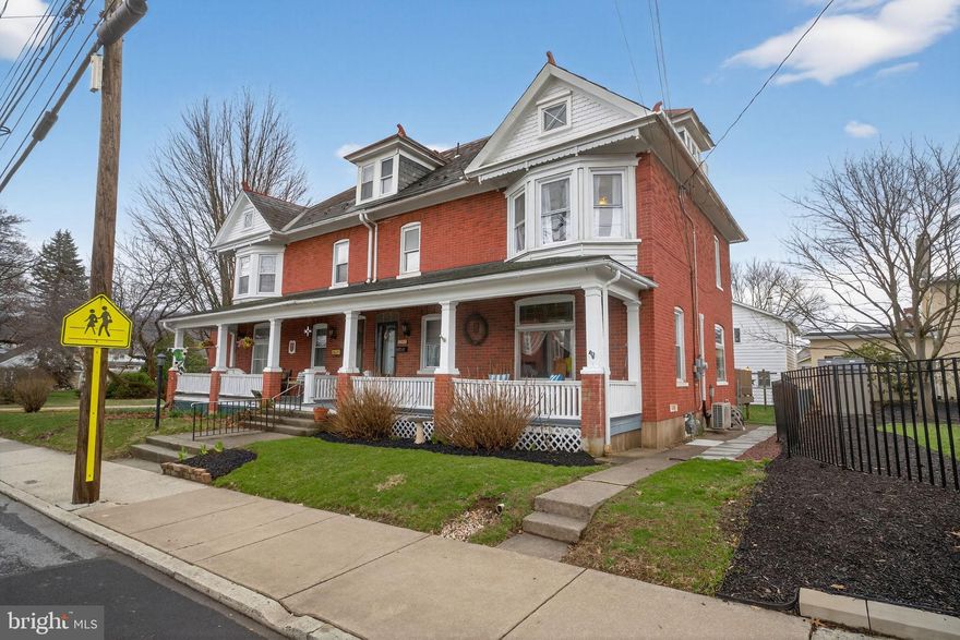 Charming and character-filled brick twin located within walking distance to Emmaus High School. Built in 1911, this thoughtfully updated home blends original craftsmanship with modern conveniences throughout its nearly 2,000 sq ft of living space. The covered front porch welcomes you into a warm and inviting foyer featuring exposed brick and beautiful original woodwork. The main level offers a spacious living room, formal dining room, updated kitchen with granite countertops, and a stunning two-story breakfast nook filled with natural light. A convenient half bath completes the first floor. Upstairs, the second level includes three bedrooms, a loft area, full bathroom, and a dedicated laundry space. The third floor provides a private fourth bedroom along with an additional full bathroom—ideal for guests or a primary suite option. Outside, enjoy a fenced yard, back deck, and a detached two-car garage with additional storage space above. Conveniently located near shopping, dining, and major highways, this home offers both charm and accessibility. A rare opportunity to own a timeless home with character and space in a prime location.