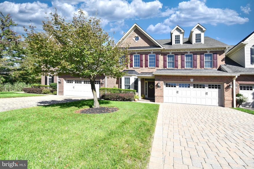 Nestled on a premium lot backing to woods in the prestigious 55+ resort style community of Delancey Court is this gorgeous, custom carriage home. The entry is grand and opens up to a soaring ceiling, eye-catching curved staircase and generously sized spaces all graced with hardwood floors and upgrades at every turn. The formal living room and beautiful wainscoted dining room with tray ceiling are designed to entertain on any scale. The gourmet kitchen is a chef's dream! The custom over-sized kitchen island offers plenty of counter space and seating. With  42 inch raised panel cabinets, granite counter tops and beautiful  backsplash, it creates the true heart of this home. The light filled breakfast area overlooks the oversized trex deck  and has convenient access to the outside. This tranquil space backs to the woods creating privacy and a place to unwind. The two-story gathering room has plenty of windows, offering natural light, and a handsome gas fireplace. The main suite is conveniently located on the first floor and features a large walk-in closet with built-ins, a tray ceiling, additional storage space and a luxury bath. The bath features a frameless walk-in shower, soaking tub and dual  vanities. Beautiful  hardwood flooring can be found throughout the main floor. Upstairs you will find a spacious open loft area with views of the family room and foyer. Two large bedrooms with walk-in closets share a full hall bath. There is also additional storage space. A bonus 3rd level  can be utilized as a home office, a quiet, private respite for guests or an additional entertainment area. There is also plenty of additional storage space available along with access to the attic storage. Premium details such as custom millwork, furniture grade cabinetry, and recessed lighting can be found throughout the home and defines perfection.  The heating and air conditioning system is barely 2 years old! The windows have been treated with 3M sunshield, and feature Hunter Douglas fabric shades! The garage floor has been treated with a slip proof Rustolium coating. This home was designed for maximum luxury with minimal maintenance. Styled after historic Philadelphia neighborhoods with brick exteriors and cobblestone driveways, Delancey Court is a premier active-adult community featuring a state-of-the art clubhouse, fitness center, indoor and outdoor pools, bocce court, conference room, game room and great room with a catering kitchen. All of this in a sought-after location close to Newtown Borough with its shopping and dining, access to I-295 making travel to Philadelphia, Princeton and New York an easy commute. This home shows like a model home. Move right in!