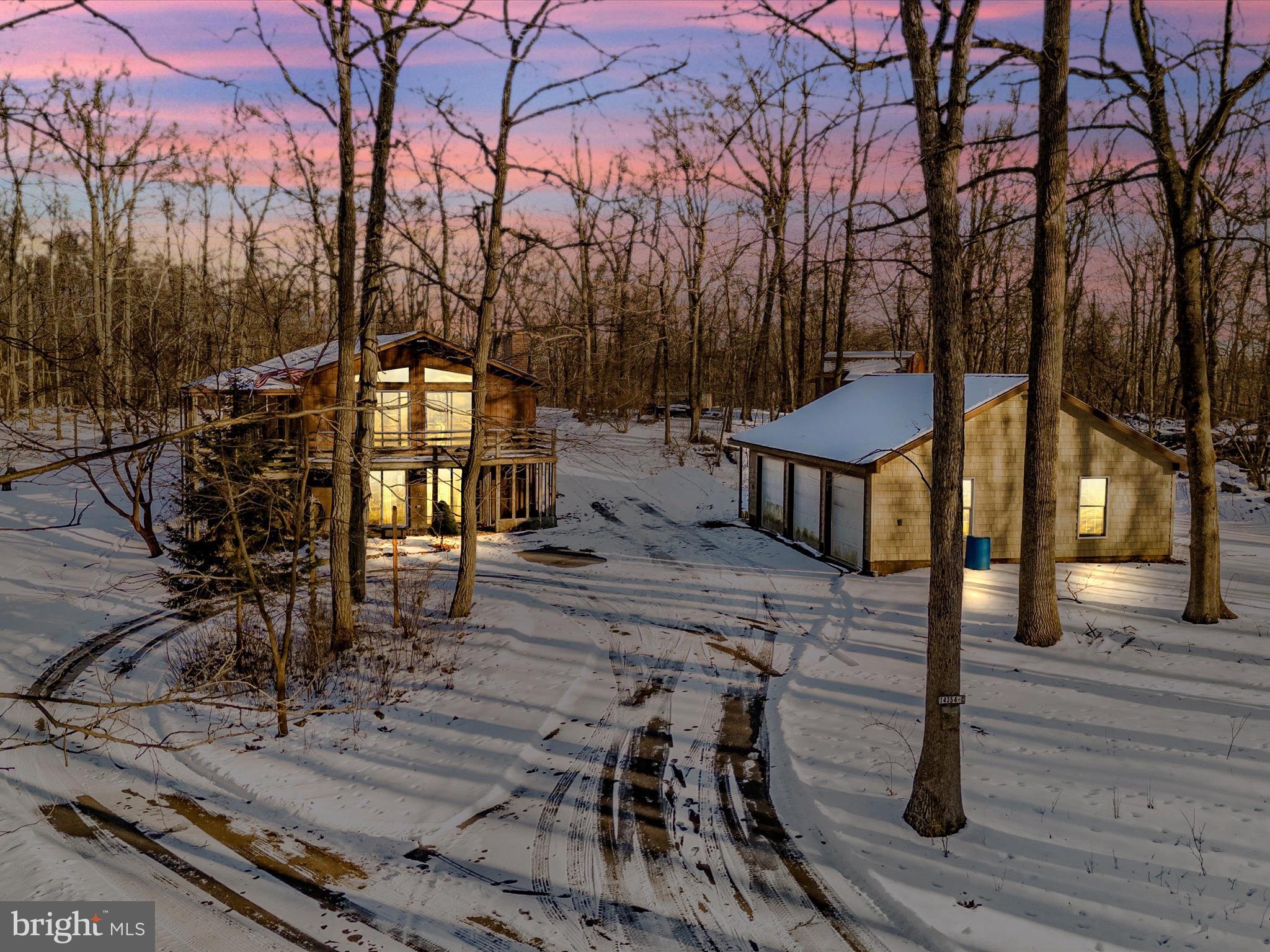 Discover a true outdoor enthusiast's paradise on over 12 acres of pristine hunting grounds, rich with wildlife. This modern contemporary home is nestled along a private, secluded lane off Brown Road, providing tranquility and stunning natural beauty.
*Spacious Living: This home boasts three bedrooms and two full baths, featuring a Great Room with a striking stone fireplace and new gas logs.
*Versatile Basement: This full walkout basement includes an additional wood stove and is ready for your personal touch. It has roughed-in plumbing and electrical for potential extra recreational space, as well as another full bath.
*Emergency Preparedness: The home is wired for an emergency generator for your peace of mind.
*Scenic Views: Enjoy breathtaking views from five sliding glass doors that open to a wrap-around deck with a gazebo, perfect for all four seasons.
*Additional Amenities:
*A fully equipped workshop/shed with electricity.
*Upgrade of electric service that runs to the garage w/its own remarks
*The wood stove in the garage also conveys, and the chimney is already installed in the garage, so it just needs to be hooked up.
*A spacious 3-car garage featuring powered doors and heating/air conditioning.
Experience the best of Catoctin Mountain living! This property presents a unique opportunity for those seeking a harmonious blend of modern comfort and outdoor adventure. Don’t miss out on this exceptional listing! For Showings, please note you will need four-wheel drive/all-wheel drive to get up the lane. It is gravel and has ruts.
