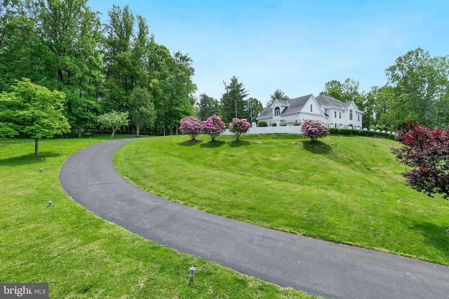 A rare gem in the heart of Bethesda, this extraordinary estate offers over 10,000 square feet of luxurious living space across four levels with soaring ceilings, all nestled on a highly private 2+ acre lot with no HOA. Extensively renovated over two years, this custom-built home has been transformed into a modern European fusion masterpiece, seamlessly blending timeless elegance with contemporary sophistication. Designed for both indoor and outdoor living, the property features 2,000+ square feet of bluestone patio spaces, providing the perfect setting for entertaining or enjoying serene, spa-like views of the adjacent protected parkland. The expansive driveway accommodates 10+ cars, complemented by a spacious 3-car garage for secure parking and storage. RE2C zoning allows for exciting possibilities, including the potential to build an additional dwelling unit (ADU), a pool, or even a private sports gymnasium. The home also boasts a fully independent lower-level suite, ideal for an in-law or au pair living space. From the moment you enter, a dramatic two-story foyer sets the tone for elegance, featuring a modern chandelier, Grecian marble floors, a curved open staircase with a loggia overlook, and beautifully cased archways. The main level impresses with 9.5-foot ceilings, extensive millwork, large-plank LVT modern gray flooring, and four fireplaces. The centrally located great room stuns with a soaring two-story Palladian window, glass doors opening to the backyard, cathedral ceilings, a wine bar, and a cozy wood-burning fireplace set within a striking river stone accent wall. The newly completed chef’s kitchen is a culinary dream, featuring Calacatta quartz countertops, a waterfall-edge island, a walk-in pantry, and a bright breakfast room with direct patio access. The main level also includes a spacious office with panoramic windows, a fully renovated full bath, and a stylish powder room. The 1,500+ square foot owner’s suite is a true retreat, featuring a sitting room, a private balcony, a dual-fuel fireplace, three or more walk-in closets, and a spa-like bath with an oversized glass-enclosed double shower, jetted soaking tub, and separate vanities. The second level offers three additional spacious bedrooms and two renovated full bathrooms, while the versatile fourth level features a seventh bedroom with cathedral ceilings, skylights, a private en-suite bath, and an upper-level laundry room, perfect as a playroom, office, or art/yoga studio. The multi-purpose lower level has been thoughtfully redesigned for full independence, featuring a recreation room, a lounge area, two bedrooms, a full Jack & Jill bathroom, a new laundry room, and a fully equipped kitchenette. Situated in the prestigious Palisades community, this home borders scenic golf courses and offers easy access to Washington, D.C., major airports, and the Whitman school cluster—an exceptional opportunity in one of Bethesda’s most sought-after locations.  For ariel view go to :  capitalskyeye .com / virtual / capriplace