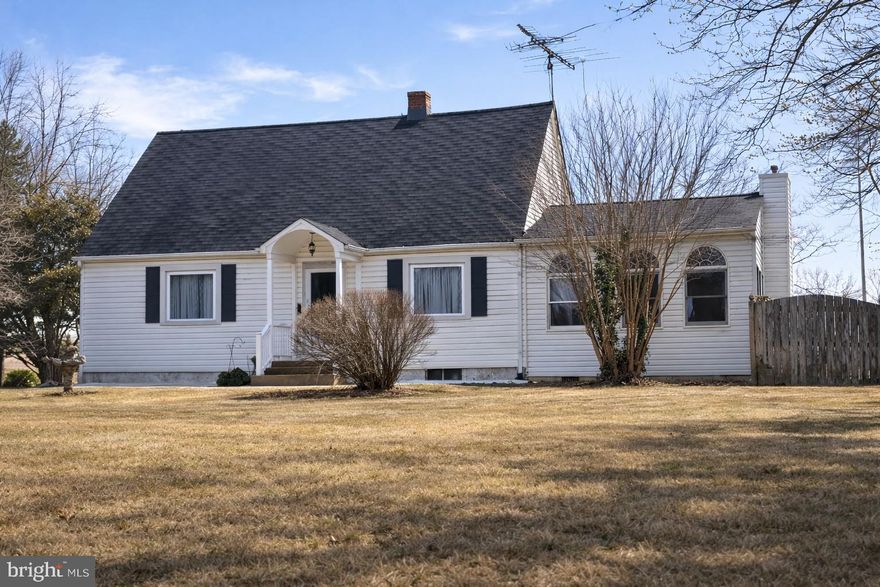 Welcome to 12 Porter Lane, a classic Cape Cod–style home built in 1953, situated on a spacious 0.66-acre lot in Fredericksburg. This unique property backs directly to Stafford High School’s football stadium, offering an elevated, “eagle-eye” view of the action—pull up your chairs in the backyard and enjoy lively afternoons and evenings right from home.

The entryway features tile flooring and wood paneling. The living room, dining room, and hallway showcase original, gleaming hardwood floors, adding warmth and timeless character. 

The updated kitchen includes maple cabinetry, quartz countertops, a stove, a built-in microwave, a refrigerator with an ice maker, a dishwasher, and laminate flooring. Permitted additions (per owner) expand the home’s functionality, including a bright, spacious family room with laminate flooring, a propane floor stove, and 12 windows that provide abundant natural light.

The main level offers a full bath with a shower, laminate flooring, and original hardwood flooring beneath. An office with hardwood floors, shelving closet, and direct access to the family room adds flexibility. In the not-so-distant past, a successful paving business was run from this home. A main-level bedroom (not to code) features hardwood flooring and direct entry into the family room addition.

Upstairs, you’ll find two additional bedrooms with carpet, a full bath with a shower only and laminate flooring, a generously sized hallway closet, and attic access.

The unfinished basement includes interior stairs, walk-up access, a washer and dryer that convey, and county water and sewer. Major updates include a roof replaced approximately 10 years ago and a 1-year-old heat pump with propane backup.

Outdoor features include a carport with paved driveway, an expansive deck wired for a hot tub and covered by an existing gazebo, a fully fenced backyard, and existing water lines from a former above-ground pool. Additional exterior highlights include a slate front patio and gutter system.

A detached two-car garage offers extra storage space behind the parking areas and presents potential for conversion to a second dwelling unit or studio (buyer to verify).

This distinctive property combines vintage charm, thoughtful updates, and a truly one-of-a-kind setting—an opportunity you won’t want to miss.