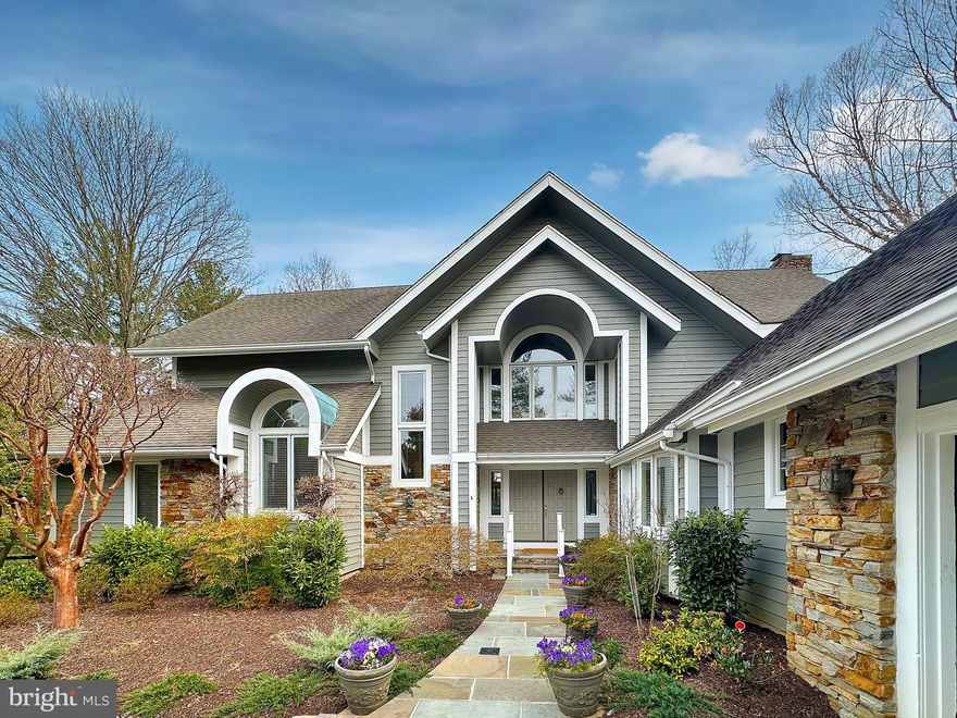 Travel down a shared driveway to this beautiful Ruxton oasis. This spacious stone and cedar contemporary home sits on over .8 of an acre with a private yard and professionally landscaped gardens – providing the perfect “close in” Baltimore County location with easy access to Towson, I-83 and the Baltimore beltway.

1915 Old Court road is a lovingly maintained 5 bedroom, 4.5 home with a floor plan truly made for today’s lifestyles.  Looking for an updated eat-in kitchen with connecting family room?  Check.  Primary bedroom suite on the first floor?  Check.  2 car garage?  Art studio or workshop? Finished basement with a walk out to a flat yard?  Check, check, check!  This one really has it all. 

The main level features expansive cooking and gathering spaces.  You’ll be wowed by the large vaulted living room with wood burning fireplace and beautiful glass-enclosed semi-circular conservatory. Pass through a formal dining room into the large chef’s kitchen that shares a den and sunny breakfast room leading to one of three rear deck and outdoor entertaining areas.  There is also a pantry, powder room and mudroom just off the garage.  At the other end of the main level you will find a primary bedroom suite with two walk-in closets and a large primary bathroom as well as another bedroom (perfect as a guest room, home office or nursery) and full hall bath.

The 2nd level features three nicely proportioned bedrooms and 2 full baths as well as significant storage.  In addition to the almost 3,900 sq feet of above grade living, you’ll also benefit from the lower level featuring another 2,400 sq. feet of finished and unfinished spaces.  The highlight is a large family room/rec room with a second wood burning fireplace, home office space with custom built-ins, and double doors walking out to the beautiful rear yard.  You’ll also find a 40’ brightly lit artists studio/workshop space, laundry room, and storage rooms.

Spend sunny mornings and cool summer evenings under the covered porch or on one of the decks watching children, friends and pets play in the various yard areas. There is a perfect opportunity to add a pool as well.  With so much to offer, you’ll love coming home to your little piece of the world.