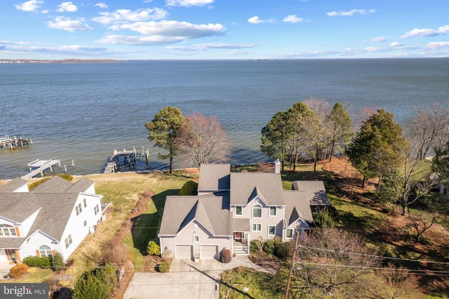 Captivating water views!  This waterfront residence situated on the shores of the South River flowing into the Chesapeake Bay is nestled in the Saunders Point community near both Triton Nature Park and Mayo Beach Park. This lovingly maintained 5 bedroom, 3 bath home is set on .61 acres with an impressive 160 feet of water frontage. Carefully designed to maximize the water vistas, the two-story home boasts views from almost every room and features a screened porch with wrap around waterside deck with hot tub. On the main level, the gourmet Kitchen, boasting a large L-shaped island, dining area, spacious Family Room with fireplace, home office, full bath and bonus room provides a warm and inviting space for gatherings of all sizes. The unprecedented water views continue upstairs from 3 of the 4 bedrooms including the Primary suite with soaring ceilings, private ensuite bath and walls of windows framing the ever-changing scenery of the Chesapeake Bay. A private sanctuary for relaxation after a long day on the water! Venture outside to savor the breathtaking panoramic views, including the iconic Thomas Point Lighthouse, Thomas Point Park, and the Kent Island shoreline. The sprawling lawn, lush landscaping and expansive deck provide an ideal setting for entertaining, complemented by sensational sunrise views. The private pier is equipped with 300 sqft. sun deck; a perfect place to watch the Bay boating activities, and boat lift.  The ideal location offers a quick boat cruise to Annapolis Harbor, the Bay Bridge and beyond. Completing this remarkable property is an over-sized 2-car garage with tons of storage. Welcome Home!