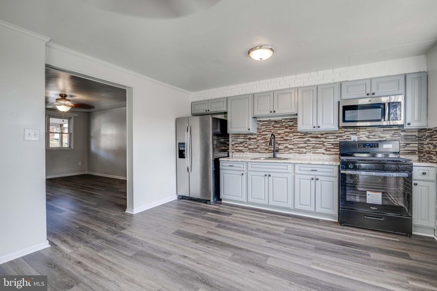 Live authentically.  Classic Charm City townhouse.  Be greeted with charming covered front porch.  Open, bright, spacious flow from living space to living space. Thoughtfully updated throughout including new roof (2023), new outlets/switches, new stove and new flooring.   Expansive kitchen leads to massive deck ideal for entertaining and enjoying Baltimore evenings.  Partially finished lower level complete with added interior space that leads to your off street rear parking. Hit the easy button in a location with zippy access to everywhere you want to be. Cultivate your existence.  The art of uniting human and home.