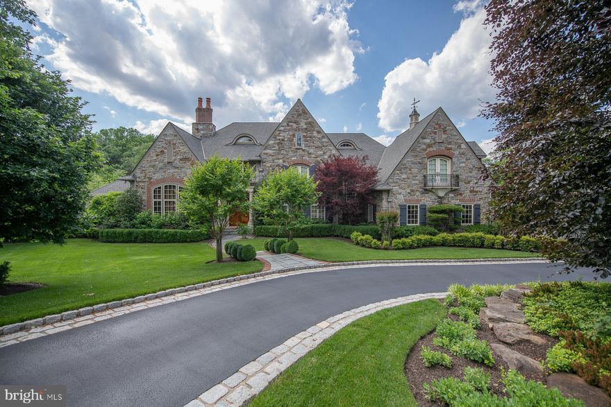 It's all in the details of this stunning custom ten year old estate set on the quiet cul de sac of Winfield in Devon.  2.7 acres of magnificent fenced in grounds featuring lovely English style gardens. Historic Spanish cedar doors welcome you into the elegant view through Foyer with balcony overlooks. Hand hewn wide plank hickory floors grace most of the first floor. The formal dining room is adorned with Felber plaster molding and deep paneled archways.  A Library worthy of the Earl of Grantham was constructed by Jonathan Trueblood stands off of the foyer with majestic 14 foot ceilings, California Elm wall and ceiling moldings, and an English fireplace. The first floor gallery has wood wainscoting and leads to the dramatic Grand Room with 22' high coffered ceilings, Felber plaster moldings, a hand carved TV cabinet, a piano alcove and Francis Purcell antique mantel. Two sets of french doors lead to a flagstone Loggia. Here you'll find an outdoor cooking space, a stone fireplace, and stone balusters overlooking the grounds. The Coventry Kitchen has all the modern amenities with its Gagganau Steam oven, convection oven, and warming drawer, Thermador six burner rangetop with griddle, Miele dishwasher, stainless microwave, and paneled Subzero refrigerator and freezer drawers. The tiered island features a bridge faucet and farm sink.  A built in banquette, lighted hutch, and bookcases frame this inviting space. Treat yourself to a cappuccino with a built in Miele coffee station in the Butler's Pantry which includes a dual temp wine chiller. A four stop elevator makes getting yourself or your things up and down with ease. Off of the Kitchen is a sunlit desk with windows overlooking the gardens.  The morning room is a warm space with bead board tray ceiling and opens to the Loggia. The Kitchen wing is finished with a walk in Pantry with a Thermador fridge and cherry cabinets. The convenient Laundry Room has designer tile wainscoting, a built in ironing board, hanging rack and plenty of cabinets. There is also a full bath on this level in addition to the formal powder room.  A Georgian style second staircase with picture window leads up to a charming reading loft.  At the end of the first floor gallery is the Master Suite.  An anteroom opens into a relaxing sitting room with outdoor balcony.  The Master Bedroom features a tray ceiling with lovely moldings, and two walk in closets with built in full length cabinetry. Luxuriate in the Master Bath with two onyx top vanities, built ins, corner tub, walk in shower and domed mother of pearl ceiling. The main staircase is as grand as the room it overlooks with Ironworks railings and three balconies. Upstairs you'll find four generously sized bedrooms, each with its own en suite bath.  Bedrooms feature window seats, Juliet balconies, and walk in closets. The third floor has a huge finished space with dormers and plenty of storage space. There's no reason to leave home with the fabulous finished lower level! Your very own movie theater features reclining leather chairs and large screen.  The Family Room has a stone raised hearth fireplace and tall French doors out to a huge covered porch. The Bar/Kitchen has custom Sherman Gosweiler cabinetry and Emily Seldin stained glass windows.  A working Office is also on this level with cherry coffered ceilings, wainscoting and glass door built-ins. There is also a Playroom, a bright Exercise Room as well as a Holiday/Craft room with floor to ceiling cabinets and counters.  A marble powder room and cedar lined room and a spacious veranda complete this level.  Step out to the lush gardens and the red Japanese bridge beneath the trees encourages a reflective space. Cobblestone courtyard and garages for 5 cars include an upstairs storage space and whole home generator.  Fill your days with friends and family in this warm and welcoming home with exquisite finishes. Your new home awaits; call now to arrange for a private showing!