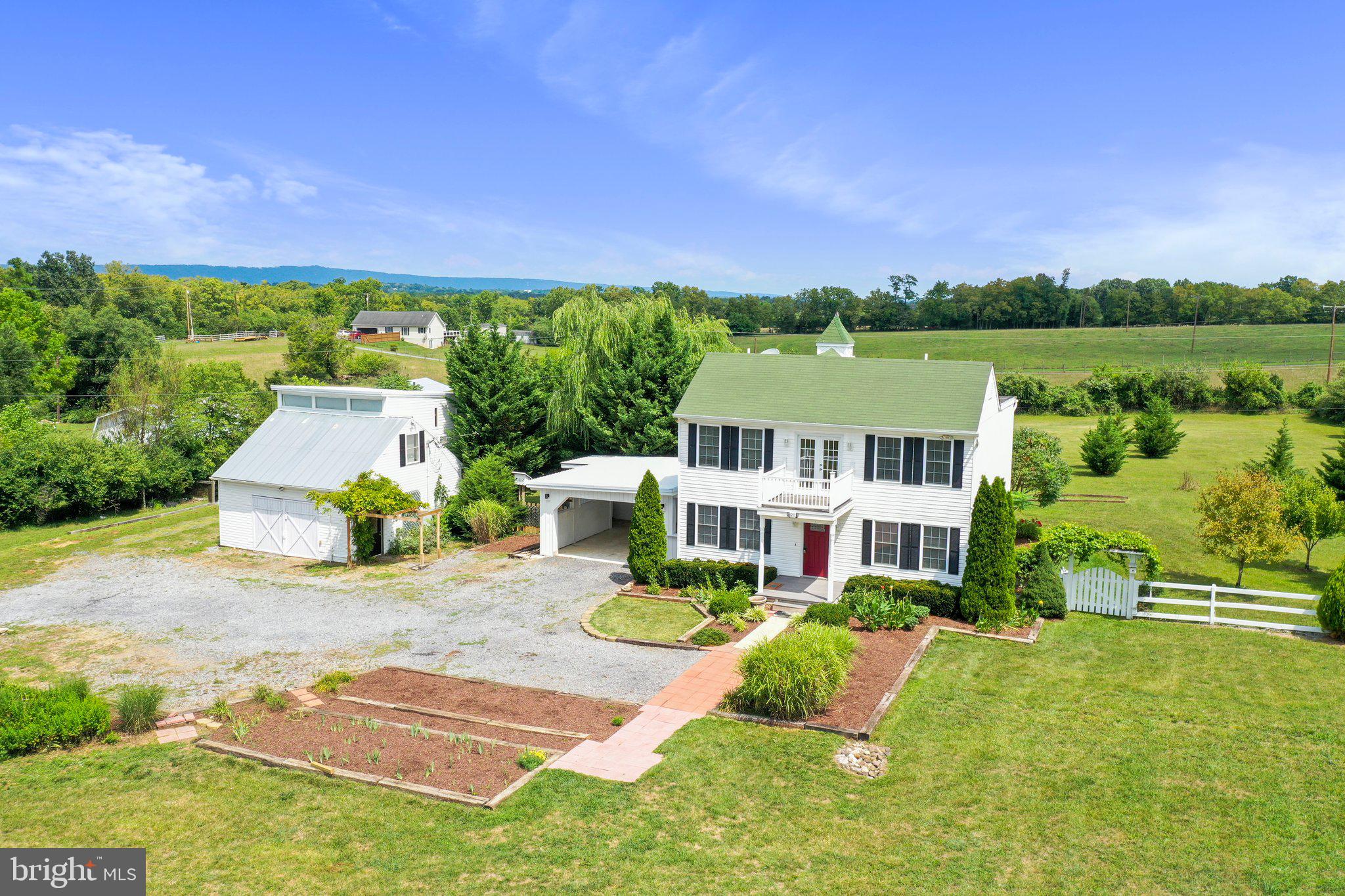 Beautifully maintained colonial situated on 5 acres of farmland! Featuring 4 bedrooms, 2.5 baths. Main level offers a separate living room and dining room. Family room with propane stove fireplace. Eat-in kitchen with tile floors and wet bar area. Bedrooms on upper level. Primary bedroom with walk-in closet and attached en suite. 2nd story balcony with a lovely landscape view. Make your way to the screened-in porch that leads right into the large deck - relaxing view of the fenced-in backyard. Oversized 1-car garage. Separate two-story shed with elevator and workshop. Plenty of space for horses - make it into your own farmette! This home has so much to offer. Schedule your tour today!