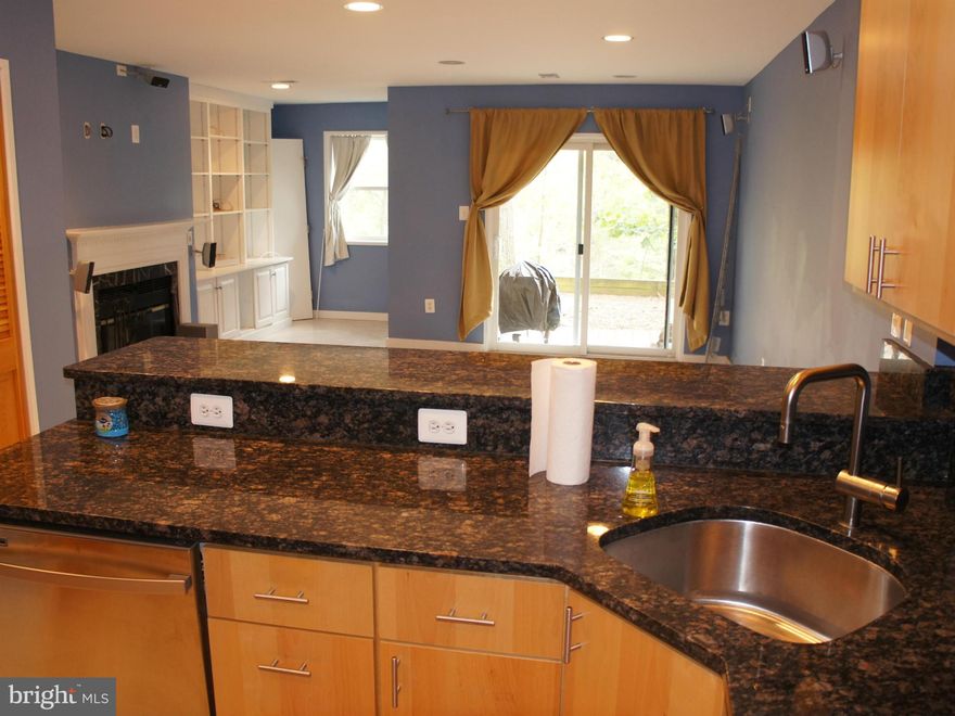 Beautifully Renovated 2-level townhouse-style condo w/2 BRs & 2.5 baths. Main level walk-out to balcony & lower level to patio with scenic view. Kitchen w/ granite tops, stainless steel appliances, and breakfast bar. All bathrooms updated, hardwood flooring throughout, Great location close to schools, shopping, entertainment and major commuter access routes.