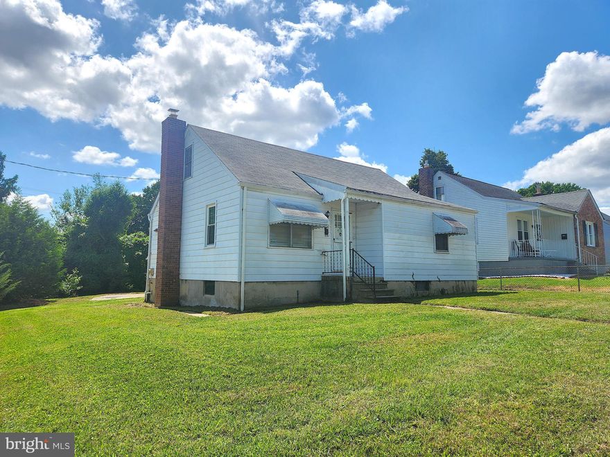 Opportunity awaits! This charming Cape Cod style home retains much of its original detail with updated utilities. Enjoy having a corner lot with a 2 car garage and large concrete driveway. The spacious living room has arched entrances to the hall & kitchen. The eat in kitchen has plentiful cabinets & counter top space. There are two bedrooms on the main level with hardwood floors & original 2 panel doors. The full bath has a mosaic tile floor of yesteryear perfectly preserved & tub shower combo. Upstairs is the third bedroom & additional bonus room, both with hardwood floors. The basement is finished in knotty pine with a built in bar & wall sconce lighting with an adjacent powder room. A large workshop with built in table & tool storage is ready for your projects. Imagine entertaining on the concrete patio adorned with your flowering plants for those relaxing summer evenings. Not only does it have great bones, many timeless items are well preserved such as the original interior doors, hardwoods, & hardware. This home is ready for your vision & sweat equity to make your own. Offer Deadline 8/15 at Noon.