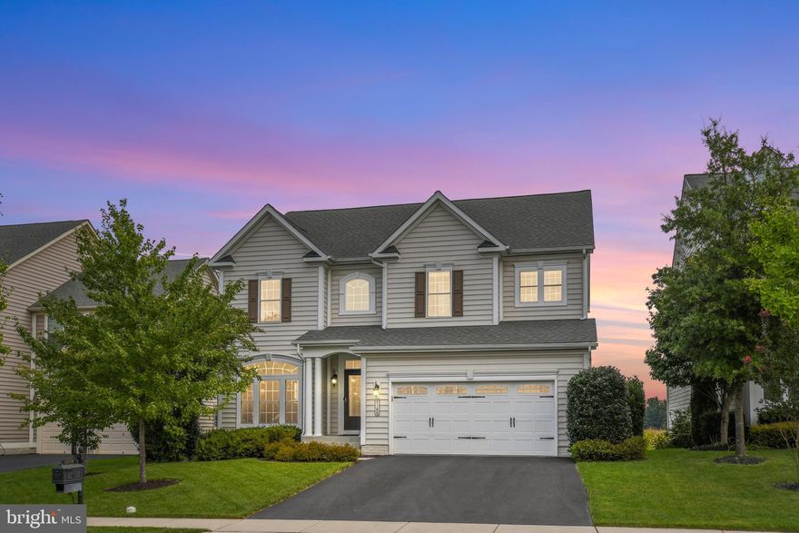 Nestled in a bucolic setting backing to farmland, this Villages of Urbana home impresses with eye-catching architectural details throughout. This meticulously maintained NV Colonial is an entertainer’s dream with open floor plan, hardwood floors, stunning gourmet kitchen with upgraded granite counters, stone backsplash, stainless appliances, large island, and breakfast bar. Enjoy coffee in the sun filled Morning Room or dine alfresco on the deck or patio while enjoying the private backyard with breathtaking views. The main level includes a Family Room with a gas fireplace, Dining Room, Living Room and Study. Upstairs, wake up in the spacious Primary Suite with panoramic views of the farm and rolling hills in the distance. Details include a tray ceiling, two walk-in closets and sumptuous bath with dual vanities, soaking tub, frameless roman shower, and separate water closet. A second bedroom with en-suite bath, two additional bedrooms with buddy bath and a convenient laundry room finish the upper level. The Lower-Level Rec Room equipped with built in speakers and surround sound is perfect for movie night or large gatherings. A wet bar with a full-sized refrigerator, game room and full bath are sure to impress. Upgrades include extensive moldings, custom lighting, iron railings, surround sound on the main and lower level, underground sprinkler system, electric car charging station and more. Hurry, this one won’t last!