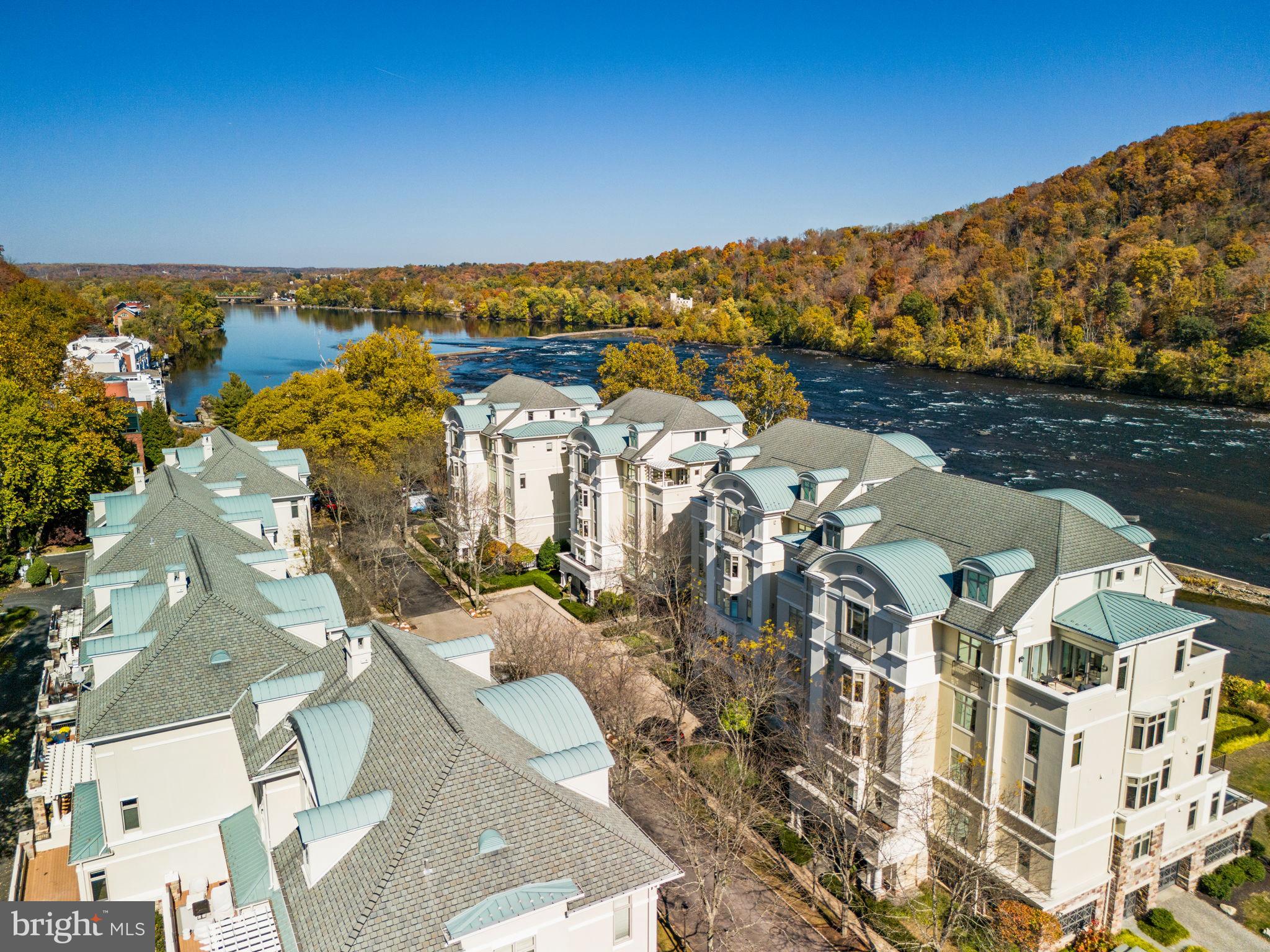 Luxury lifestyle awaits at Waterview Place on the Delaware River. This beautiful stately townhome in the prestigious gated Waterview Place Condominiums charms at the water’s edge with European style courtyard, water fountain, and professional landscaping. A private covered entryway leads to four levels of finished living space, easily accessible with a private wood-paneled elevator. You’ll enjoy 3 spacious bedrooms, 3 1/2 baths, a fourth bedroom currently being used as an office, & a comfortable open floor plan. The large living room/great room enjoys ten-foot ceilings, beautiful light, hardwood floors, wide crown molding, gas fireplace and recessed lighting. Freshly painted throughout, this home is move-in ready. The living room is open to a dining area w/built-in cabinetry & access to a private deck overlooking the canal. This long deck invites you to relax and take in the tranquil scenery, a perfect spot for morning coffee or evening night cap. Cook's kitchen w/maple cabinetry, granite counters, stainless Dacor appliances & Subzero refrigerator. Massive main bedroom suite w/sitting area, full bath w/whirlpool tub, oversized shower & 2 walk-in closets. The entire sun-filled suite takes full advantage of the views. Nearby a laundry room provides extra sink and storage. Two generously sized suites, each with walk-in closet and private bath, plus a large office share the third floor with spacious nine-foot ceilings. A windowed lower level is perfect for a family room, gym or office, with interior access to a 2-car attached garage & ample storage. Walk-in closets & oversized windows & doors throughout. An easy walk to New Hope, this condo is pet-friendly, has generous parking for guests, is in the top rated New Hope-Solebury School District, and is just a mile from the heart of New Hope with all its unique shops, eateries, galleries and the Bucks County Playhouse. An inspiring lifestyle and rare opportunity to be in the heart of the very best of New Hope.
All information in this description has not been verified and is not guaranteed. Prospective buyers should conduct their own due diligence.