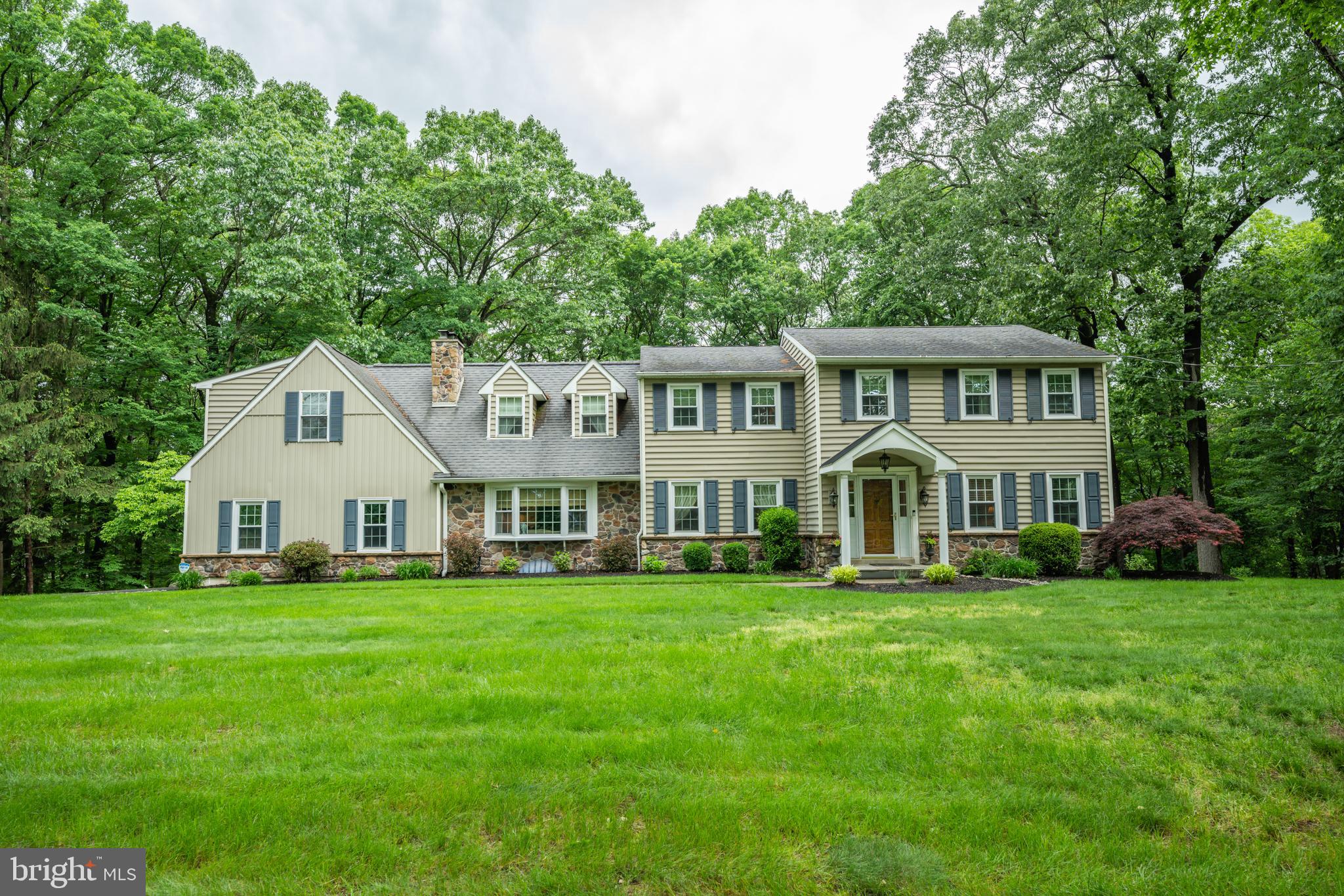 Welcome to 276 Cherry Lane – Where Charm Meets Modern Living. Nestled in the desirable Cherry Lane Acres and thoughtfully enhanced since its 2006 purchase, this beautifully updated colonial blends traditional elegance with modern comfort on 1.52 acres of private, wooded beauty. From the moment you enter, you’ll appreciate the balance of simplicity and sophistication. To your right, a warm front sitting room; to your left, a formal dining room – perfect for hosting or everyday elegance. First floor powder room and possible bedroom currently being used as an office are just a few more steps in. And then the heart of the home: a chef’s kitchen featuring radiant heated floors, a Wolf double oven, Electrolux induction cooktop, KitchenAid French door fridge with interior filtered water, and a granite island ideal for cooking, gathering, or casual dining. The breakfast area opens directly to a deck with raised garden beds and attached sprinkler system, overlooking manicured green space and a serene wooded backdrop. The cozy family room boasts a wood-burning fireplace with original brick mantel and a large bay window that floods the space with natural light and showcases the expansive front yard. Function meets form in the spacious mudroom, complete with utility sink, bench seating, storage, and garage access—perfect for managing coats, bags, muddy shoes, or pet gear. Upstairs, you'll find four generously sized bedrooms: Bedroom 1: Ideal for guests, just across from the hall bath. Bedroom 2: Features a walk-in closet and custom built-ins. Bedroom 3: Formerly the primary suite, includes an en suite bath and sitting bench in the shower. The new Primary Suite (added in 2012): A true retreat with vaulted ceilings, dormer windows, his-and-hers walk-in closets, and a luxurious bathroom featuring radiant heated floors, dual vanities, a clawfoot soaking tub, and a stall shower with bench. You'll also love the convenience of an upstairs laundry room, added during the primary suite expansion. The finished basement offers a versatile space complete with a granite wet bar, wine fridge, and powder room—perfect for game nights or quiet evenings. Two unfinished areas provide a workshop space and additional storage in what the owners use as their "wine cellar" because as they say, "it's always just the right temperature". Modern systems and upgrades include a Bosch high-efficiency tankless boiler and water heater, well water softening and treatment systems, and a new UV germicidal disinfecting system. With a 2-car garage and space for at least five additional vehicles, this home is designed for comfortable living, productive working, and seamless entertaining. Enjoy peaceful mornings on the deck, scenic walks into Doylestown Borough, and access to a Blue Ribbon School District—all from a home that truly has it all. Don’t miss your chance to experience 276 Cherry Lane. Schedule your tour today!