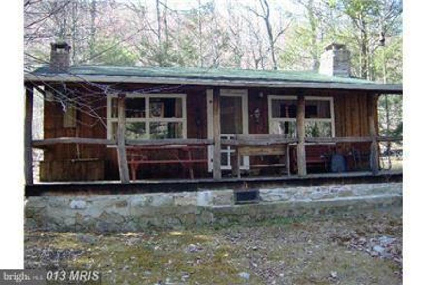 Enjoy the mountain's from this nice Chestnut Log Cabin with Kitchen, Living Room, and 2 Bedroom's... All Furnishings convey. Move in Ready.  No indoor facilities, but can be added. Gated Drive. Close to Cowans Gap State Park. Wildlife abounds. In the family for close to 20 years. Terrific time to purchase your own get-a-way.
