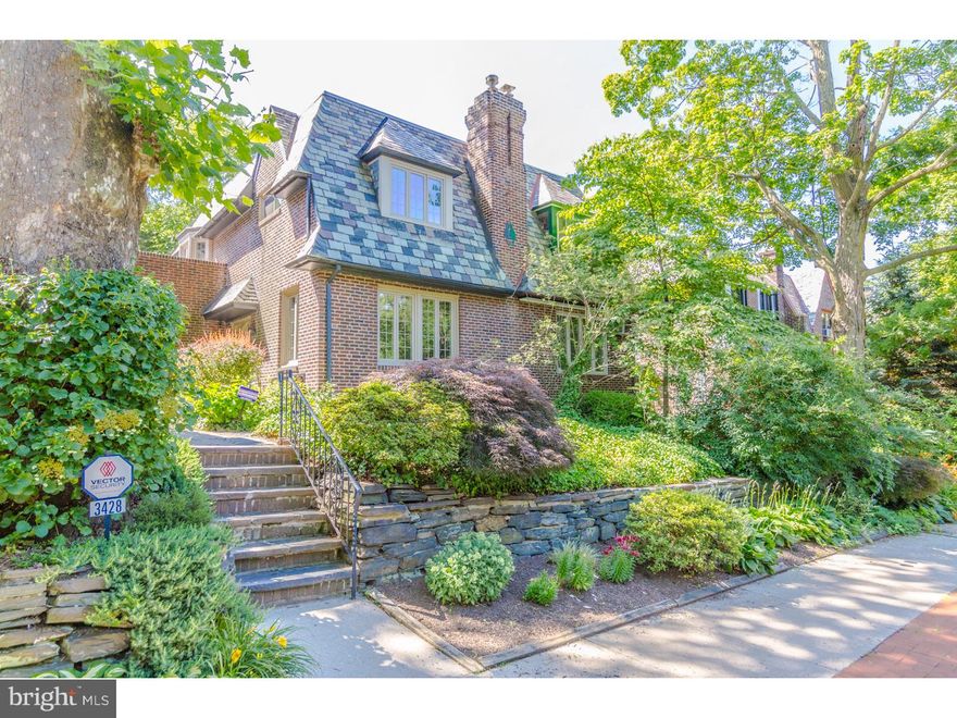 Fantastic opportunity and tremendous value on prime East Falls block with private parking.  Pride of ownership abounds in this meticulously maintained home in the heart of the coveted East Falls Historic Tudor District.  Front and side gardens with mature plantings and a stone walkway lead to a side entrance with ornate wood door.  Enter into the charming, extra-large living room with wood-burning fireplace, hardwood floors with inlay and tons of natural light from windows on two sides.  Step up to the open eat-in kitchen with granite island, gas range, plenty of cabinet space, recessed lighting and separate eating area.  Off of the kitchen is the converted garage currently used as a large dining room ideal for family gatherings.  There's also a convenient full bathroom with tub adjacent to the dining room.  Beyond the kitchen is a unique mudroom/laundry room complete with side by side W/D, additional storage and built-in work station with over-sized desk and drawers.  3 large bedrooms upstairs each with ceiling fans and a master bedroom with his/her closets.  Super clean 4-piece hall bath with skylight completes the 2nd level.  Deep semi-finished basement with mechanicals and additional storage has tons of potential and could easily be expanded.  Common rear driveway running from Vaux St. to Conrad St. provides easy access to your private parking space behind the home.  Depending upon the size of your cars and how you use the space, you could have enough room for 2-car private parking.  With new windows throughout, this home is super clean, has been meticulously maintained and shows extremely well.  Great value and minutes to Center City with easy access to 76, Kelly Drive and Manayunk.  Short walk to the East Falls train station.  Schedule your showing today!