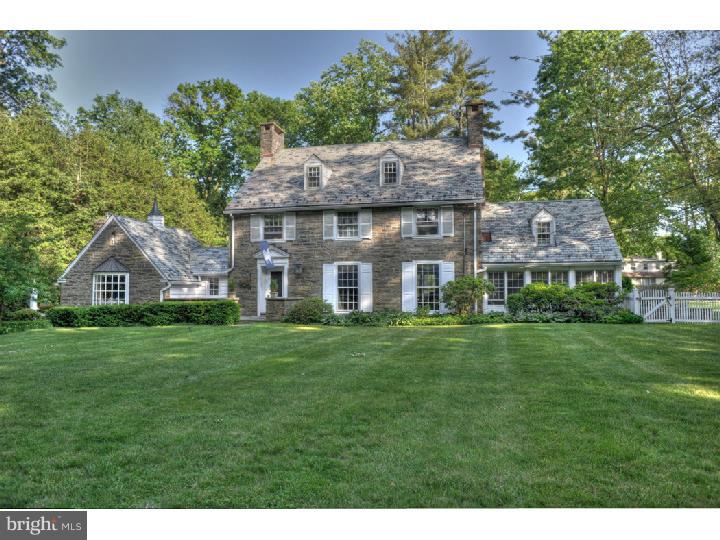 This extraordinary Stone Colonial built in 1926 is ideally integrated into its magnificent landscaped grounds. Sitting far off the road in a park-like setting, this home spares no details: Beautiful random-width, pegged oak floors, sophisticated moldings, and raised panel wainscoting throughout; Large living room with floor to ceiling windows, a gas fireplace detailed in marble and brick; Deep-sill dining room with views to the back garden and French Doors to brick terrace; Library/Family Room with built-in book shelves, a wood fireplace, and Dutch door to enclosed sun porch with stone flooring, ceiling fan, and entrance to outside terrace and yard; Family Room with pine panel walls, brick gas fireplace, wet bar, and sit-in bay window. The entire house has bright, generous-sized rooms and windows as well as an ideal floor plan for relaxing or entertaining. There is a side terrace and private backyard with an in-ground pool and plenty of room for play. This home is special in every way and is convenient to public and private schools, public transportation, interstate highways, shopping, clubs, etc.