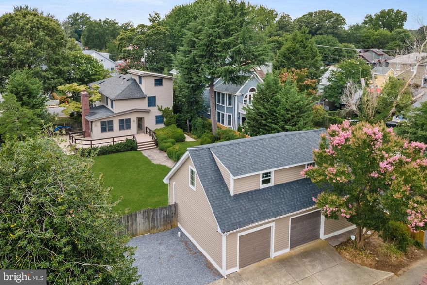 Discover the charm of this 1930 classic Eastport cottage situated on a spacious .27-acre lot, one of the largest in Eastport. The property features a bucolic rear yard,  custom landscaping with boxwoods, flowering gardens, and specimen trees, all complemented by a flagstone walkway that connects the home to detached garages and a newly completed guest suite efficiency (2021) above the garage. This charming home retains 9 original windows, has one gas and one wood-burning fireplace, and boasts several recent upgrades, including a new sewer line (2020), a roof that is 10 years old, a new hot water heater (2024), a recent boiler (2017), an A/C system (2022), a Mini Split system (2021), and a garage roof (2020). The oversized garage offers parking for 2 cars, with additional driveway parking for 3 cars accessed via Howard Dignen Alley. Located just half a block from Bakers and Co  and minutes to all the eateries and amenities Eastport has to offer, this property is a rare find. Don't miss the chance to own a piece of Eastport history with modern comforts.