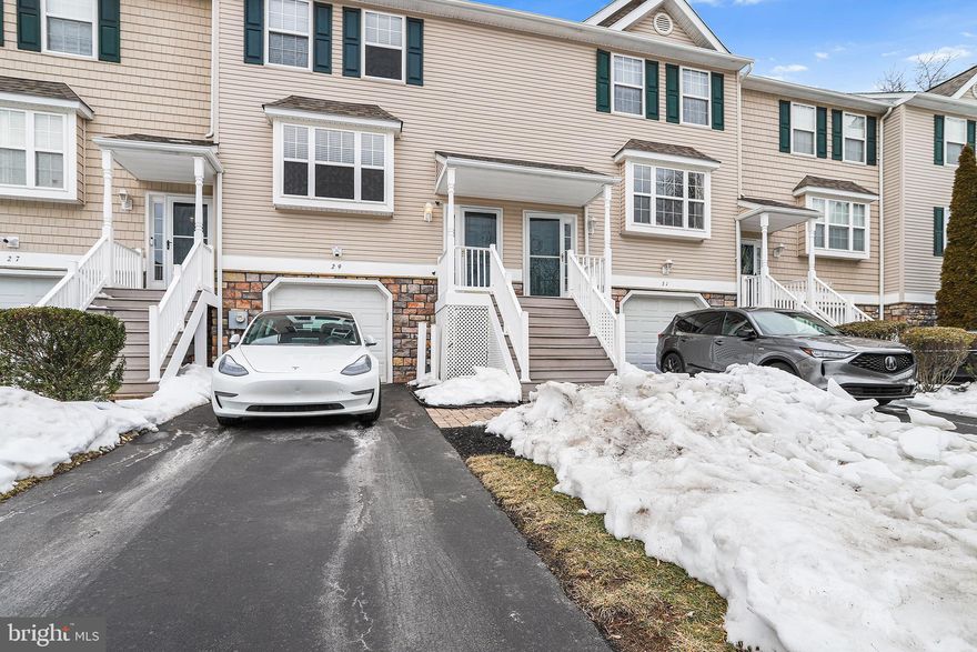 Welcome home to 29 Hoag Lane, located in the sought-after Spring Valley Way Community. Upon entering, you’re welcomed into a beautiful open-concept living, dining, and kitchen space, a rare and unique offering for the neighborhood.  The main floor of the home features lovely hardwood floors complemented by a neutral paint palette throughout. The kitchen is complete with updated granite countertops, extended kitchen island, newer appliances, and sliding glass doors that open to a nice deck and private back area—perfect for outdoor entertaining. Completing the main floor is a convenient powder room. The upper level offers a primary bedroom with neutral paint, carpeting, multiple windows providing abundant natural light and a spacious walk-in closet. The ensuite bathroom has been tastefully updated with a walk-in shower and a new vanity. Two additional nicely sized bedrooms share a hall bathroom featuring tile floors and a tub/shower combination. The beautifully refinished lower-level features LVP flooring, a large closet, and neutral paint throughout, offering versatile additional living space ideal for a playroom, home office, gym, or family room. The lower level also offers unfinished space perfect for storage, a dedicated laundry area, and convenient access to the single-car garage. Notable upgrades include a new roof with a transferrable warranty, a new water heater, and a high-efficiency heating system and low HOA fees. Lovingly maintained and thoughtfully upgraded, this home is ready for its next owners.