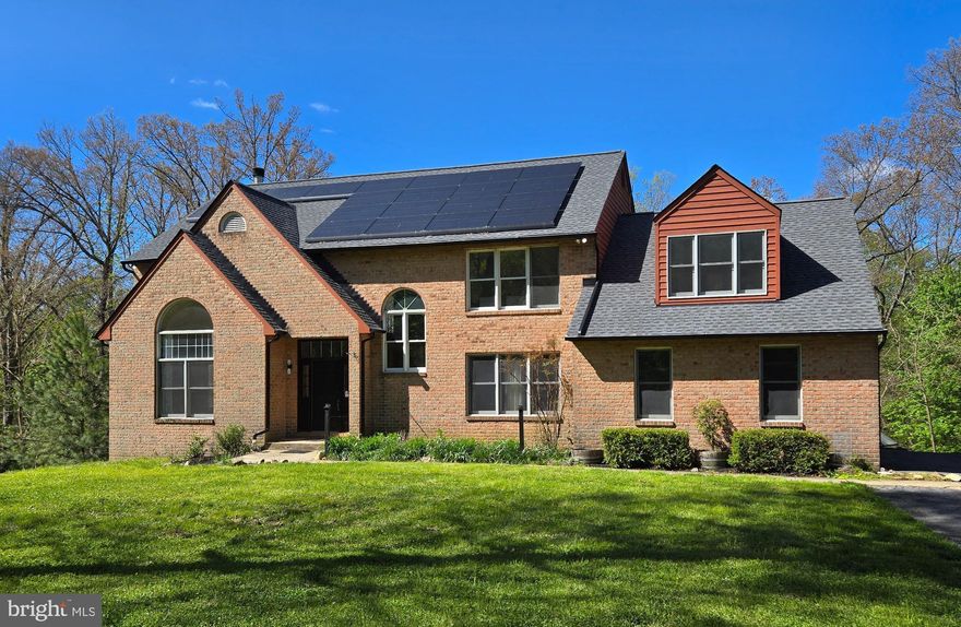 Nestled in the highly desirable Woodleaf subdivision, this custom-built brick estate offers an exceptional blend of privacy, luxury, and modern efficiency. Privately situated on 13+ secluded acres, a breathtaking 150-yard tree-lined driveway creates a grand first impression and a true sense of arrival. With over 4,000 square feet of thoughtfully designed living space, this impressive home features 5 spacious bedrooms and 4.5 baths. The well-appointed floor plan offers comfortable everyday living while seamlessly accommodating gatherings and entertaining. The expansive eat-in kitchen is a chef’s delight, complete with cooktop, wall oven, generous counter space, and abundant cabinetry. A cozy wood-burning fireplace warms the main level, creating an inviting atmosphere during cooler months. The lower level boasts a massive workshop—ideal for hobbyists, craftsmen, or creative projects. Recent upgrades provide peace of mind, including a newer HVAC system, dishwasher and brand-new water heater. The roof and gutters are only two years old! This all-electric home is designed for efficiency with leased solar panels and two Tesla backup batteries, helping to significantly reduce utility costs while providing reliable power during outages. Relax year-round in the four-season room or unwind outdoors on one of two spacious decks overlooking the serene, protected watershed acreage. The property invites outdoor adventure with room to explore, hike, and garden. A greenhouse extends your growing season, and the established chicken coop and run add to the homestead charm. Keep the family pets safe too with an invisible fence that's already installed! With county approval, there is even potential to add stables and create a private horse property. Enjoy the tranquility of country living without sacrificing convenience. This extraordinary Woodleaf estate truly offers space, sustainability, and endless possibilities.
