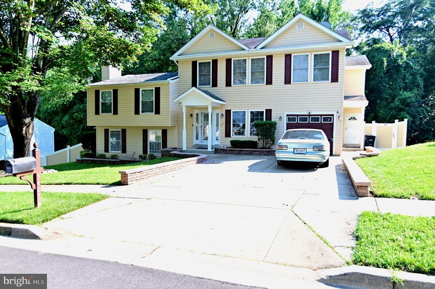 Come witness this larger than it appears, lovely colonial with four finished levels providing ample space for comfortable living, entertaining, or even rental income. The main level features gleaming hardwood floors, a formal living and dining room, a gourmet kitchen with granite countertops and stainless steel appliances, a bright morning room off the kitchen, and a main-level primary suite with a walk-in closet and a luxurious ensuite bathroom complete with soaking tub and separate shower. Enjoy easy access to an expansive two-level deck perfect for outdoor gatherings.  The second level offers three generously sized bedrooms and a fully renovated full bath with custom tilework. The top level can serve as a private in-law suite or potential income-producing unit with its own HVAC zone, a spacious bedroom, huge walk-in closet, full bathroom, area for kitchenette, living area, flexible second room (office or bedroom), and direct access to the upper deck.  The lower level includes a cozy recreation room with fireplace, full bathroom, laundry room, and an additional flex space for your needs. Outside, the fenced backyard features a large patio, established slab for a future gazebo or deck, and room to relax or entertain.  This is a rare opportunity to own a versatile, multi-level home with endless possibilities and potential income.