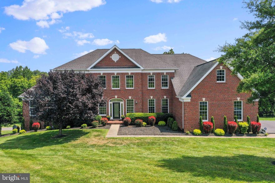 REDUCED!!Fabulous  Five Bedroom /Five Full Bath home in The Estates of Shenstone Farm. Stunning Hampton model featuring 5392 Sq  Ft of gorgeous light filled space on the Upper 2 levels and 3038 Sq Ft in the newly finished (2022) Lower Level.  If you love to entertain you will  LOVE this floor plan!! Step through the front door to the dramatic foyer flanked by two beautiful curved staircases and gleaming marble floors. From here you flow into the heart of the home- the dramatic 2 story spacious Family Room.  Featuring a cozy yet elegant Fireplace, beautiful hardwood floors, tons of windows flooding the room with natural light, and a rear staircase making for ease in everyday living. The Family Room opens to the well appointed Kitchen with a fabulous layout featuring space for everyday dining and an HUGE island ideal for large parties or everyday cooking.  Granite countertops, stainless steel appliances, and french doors leading to the refinished deck (Trex) Just off the kitchen is also a Mud Room complete with planning desk and cabinets, a large laundry room with shelving and and access to the 3 car side load garage. The entire main floor of the home shines with like new wood floors- the entertainment scaled dining room has a tray ceiling and elegant trim. Main level rear study (the ideal "work from home" spot with high speed Internet )that overlooks trees and neighboring pond. Formal Living Room off  the Foyer opens to the Family Room and the conservatory making this a functional floor plan and a space you can use and enjoy esp for larger gatherings. The side conservatory has many potential uses.  Ideal music room, billiards, or just a peaceful retreat for reading, main level playroom or second work space. Upstairs you will find a dramatic open hallway overlooking the family room leading to all 4  En-Suite Bedrooms. The Owner's Suite is a private and luxurious with wood floors, a sitting room, beautiful tray ceiling and two walk in closets including the HUGE "Her" closet. The Owner's Suite bath has two water closets and two large vanities placed on either side of the large soaking tub.  All remaining upper bedrooms feature plush carpet, large closets and private baths. Downstairs in the walk-out basement you will love the crisp and newly finished  (over 3000SF) space featuring a well lit recreation room w/ tons of recessed lights, plush carpeting and luxury plank flooring. A gym/playroom space and a Lower level bedroom as well as a Spa like Full Bath. There is also a large storage area with ample space. Walk out area features a patio for an additional outdoor entertaining space and access to the newly fenced rear yard.  VERY Privately situated on 3.2 open acres acres with pastoral views, tree lined, fenced yard, & views of neighbor's pond. You will love the flowing small stream (outside of fenced area and large yard for play. All paved roads lead to this Country Estate home only 5 minutes to historic downtown Leesburg. HIGH SPEED INTERNET-DON'T WAIT AND PAY A PREMIUM FOR NEW CONSTRUCTION!!