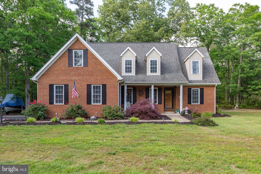 As you turn into the Estates of Lee-Jackson you just get a feeling of home. This sought after community is a one of a kind that you have to see for yourself. This home is tucked back near the end of the cul-de-sac hidden away from the road. As you pull into the lane you will see a beautiful brick cape cod with well-kept landscaping. Walk up the side walk to the front door and smell the roses. As you are greeted by a covered porch you will just be anxious use to get inside and see the rest. The home welcomes you with hardwood floors, high ceilings, and warm tones all around.  Follow through to the formal dining room and glance down the hall to see a updated half bath laundry on the main floor and access to your two-car garage. Continue on to the open concept of living room, eat-in dining, connected to your kitchen. This kitchen has granite counter tops, stainless steel appliances (to include a gas stove) and a pantry. It's so easy to see yourself preparing meal and being part of the entertainment. This home has it all to include a owner's suite on the main. Thats right! A large owners suite on the main with a his-and-her's closets! Upstairs there are three large bedrooms with a jack and jill bathroom to share. It doesn't stop there... this home also offers a loft that can be an office, additional living space, craft room or more. The home sits on 1.73 acres that backs up to the Chancellorsville battlefield and parks that has walking\jogging paths and 
wildlife for you to enjoy. Sit and sip your favorite drink in the back yard gazebo (conveys) and enjoy your raised garden with a rain watering system. This home is ready for you to come and enjoy and make it your forever home! 

The Main floor was built to be wheelchair accessible to all rooms and a ramp can be added back into the 
garage to allow for exterior access.