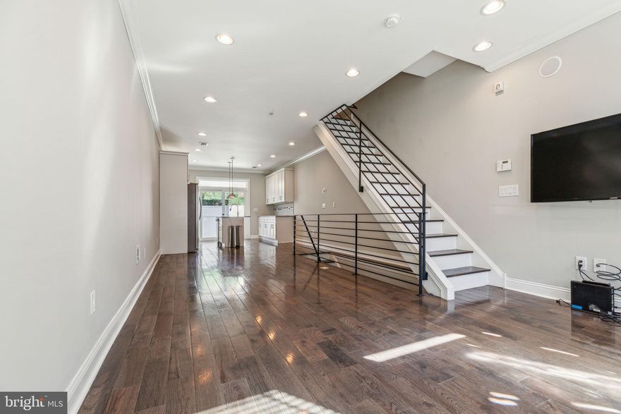 Located on a desirable residential street, this beautifully updated home offers modern finishes and thoughtful details throughout. Step inside to find hardwood flooring, upgraded bullnose corner walls, recessed lighting, and large windows that flood the space with natural light. A sliding glass door in the kitchen enhances the open, airy feel. The spacious living room features built-in speakers, while the open dining area accommodates any layout to suit your style. The redesigned kitchen is a chef’s dream, offering granite countertops, under-cabinet lighting, stainless steel appliances, a stylish tile backsplash, and ample cabinet space. Sliding doors lead to a private concrete rear yard—perfect for relaxing or entertaining. Upstairs, two bright bedrooms provide generous closet space, and a full bathroom features a tiled tub and shower. The third floor is dedicated to the luxurious primary suite, complete with a walk-in closet, a tray ceiling with ambient rope lighting, and a spa-like bathroom with a frameless glass-enclosed stall shower. A wet bar on this level leads to a full-sized roof deck with built-in speakers and lighting, offering breathtaking city views. A finished basement adds valuable living space, perfect for a home office, gym, or media room.
This home is ideally located near some of the best attractions and conveniences in the neighborhood, including renowned restaurants, cafes, and shops. Enjoy easy access to Fishtown and Northern Liberties, both known for their vibrant dining scenes, including spots like Suraya and Frankford Hall. Outdoor enthusiasts will love the nearby Liberty Lands Park and Penn Treaty Park, offering green spaces, recreational activities, and beautiful views of the river. Public transportation is easily accessible, and the area continues to thrive with new developments, making it one of the most desirable spots in the city. Don't miss this incredible opportunity to own a stunning home in a prime location!