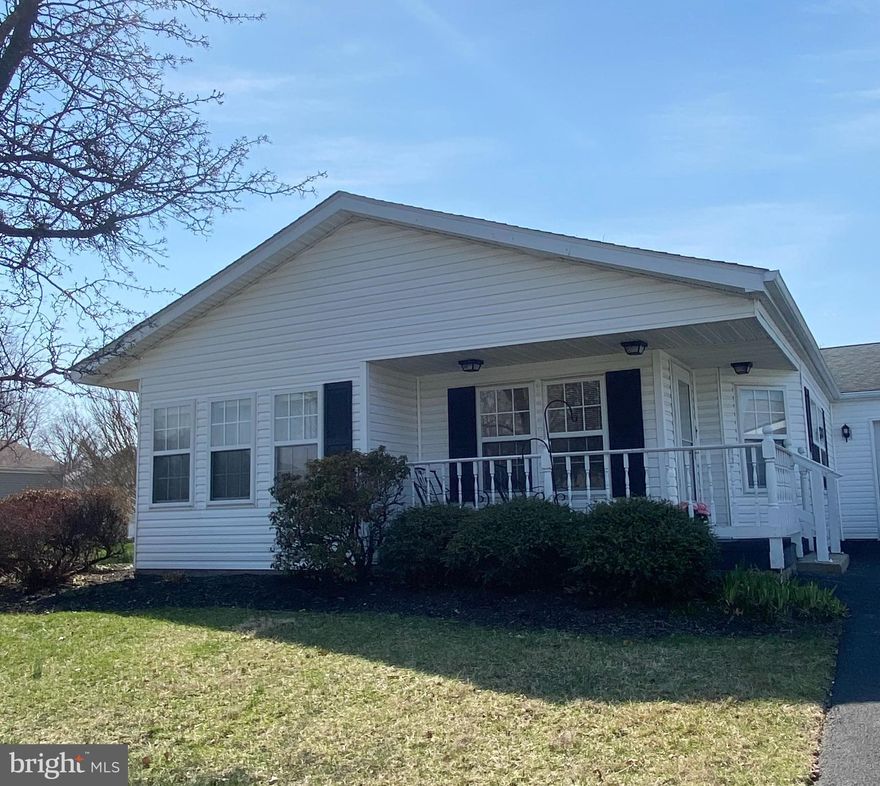 Welcome to Buckingham Springs, where a low-maintenance lifestyle gives you plenty of time to socialize by the pool or enjoy all the fun events at the clubhouse! This desirable 2-bedroom Chalfont model with garage has lots of space for all your needs. Inviting porch to watch the world go by. The open floor plan allows the living room to flow easily to the dining room, with plenty of room for large holiday dinners. The light-filled morning room with gleaming hardwood floors is the perfect spot to relax with coffee or use it as a home office. The convenient kitchen offers plenty of cabinet and pantry space. The oversized primary bedroom has a walk-in closet, linen closet and attached bathroom. The second bedroom has new carpet. Hall bath has a walk-in tile shower. The laundry room leads to the garage.  A variety of colorful flowers bloom throughout the year. Roof (2012), HVAC (2012), water heater (2019). Don’t miss the opportunity to make this house yours!