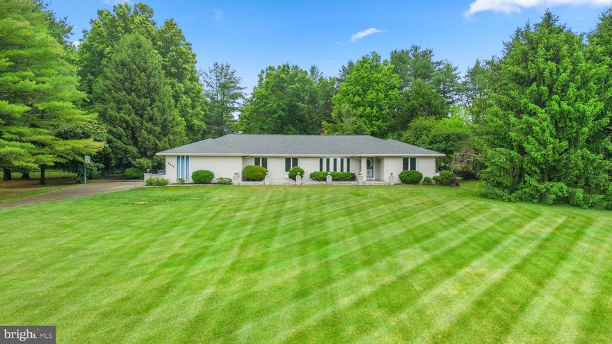 This quintessential 4,316+ sq ft custom brick rancher set in a cul-de-sac on an incredible landscaped 3.18 acre homesite in Countryside, includes a western Howard Country address and a fenced backyard showing a large deck, a paver patio, a gazebo, and a beautiful surround of mature trees. An inviting front porch draws you inside to an open foyer welcoming you and your guests in to this home featuring subtle hues with a deﬁnitive color presence decorating the interior creating an energetic and comforting atmosphere, a sunken living room with a generous bay window, a formal dining room accented by a sparkling chandelier, both rooms share a vaulted ceiling adding volume and space. A cook's haven, the kitchen presents stunning custom tile flooring, a curved designed wall of windows over the sink, plentiful Shaker cabinetry, granite counters with complementing subway tile backsplash, recessed lighting, a pantry, upgraded stainless steel appliances including a cooktop, a casual dining space, and access to a spacious family room. Aesthetically pleasing family room boasts an architectural aneled ceiling with a drop light fixture and detailed ceiling medallion, gleaming hardwoods, and a brick statement wall with a raised hearth fireplace flanked by two sets of atrium doors stepping to a deck and down to a paver patio, yard, and gazebo. The owner's bedroom offers a private entrance from the backyard, two walk-in closets, partially wooded flooring, and a modern flair lighted ceiling fan, and a private bath displaying a double bowl vanity and a step-in shower. Entertain downstairs in the rec room or relax in the endless lap pool, and for your treasures there is extra storage in a cedar style storage closet, plus a walk-up to countryside views and fenced grounds.