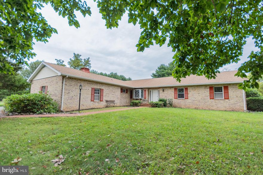 Welcome to this stunning 3-bedroom, 2.5-bath brick ranch on 2.83 acres in a well-established neighborhood. Boasting 2,256 square feet, this home features a sunken family and living room, a gas fireplace, and built-in bookcases. The kitchen shines with stainless steel appliances.  The master suite has a walk-in closet and a private bath with a shower stall. Enjoy natural light in the skylit hall bath.  Includes upgraded window shades in every bedroom and ample storage.   A park-like front yard, private backyard, and spacious patio for entertaining, this home is perfect for enjoying beautiful sunsets.  Plus, a circular paved driveway adds curb appeal! This home is a must-see!