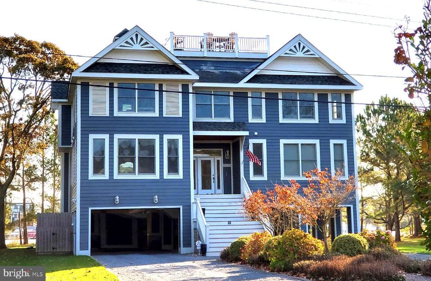 Beautiful home situated on the North Shores marina basin. This sprawling floor plan features expansive living spaces, 6 bedrooms, 6.5 baths, and over 1500 square feet of outdoor living space, including a rooftop deck with excellent views. There is potential for a private boat dock subject to the permitting process.