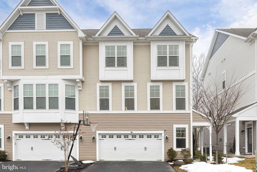 Welcome to this beautiful 3-story end-of-group townhome in the desirable newer-construction Victoria’s Crossing community of Reisterstown! Offering 3 bedrooms, 2 full and 2 half bathrooms, this spacious home provides flexible living space across three finished levels.

The open main level features laminate vinyl plank flooring and recessed lighting throughout. The living room flows seamlessly into the kitchen and dining area, creating the perfect space for everyday living and entertaining. The kitchen is equipped with stainless steel appliances, a gas stove, pendant lighting, updated cabinetry, and a center island with seating. Just off the dining area, enjoy two versatile bonus spaces,  a cozy office/reading nook and a sunroom with a fireplace and sliding glass doors leading to the deck. A convenient half bath and a large pantry completes the main level.

Upstairs, the primary suite offers plush carpeting, two walk-in closets, and a private en suite bath featuring a double vanity, tiled flooring, linen closet, and a spacious stall shower with bench. An attached bonus room provides flexible space ideal for a nursery, home office, or sitting area. Two additional bedrooms, a full hall bath with tub/shower combination, and hallway laundry add convenience and functionality to the upper level.

The lower level includes a carpeted family room with a half bath and sliding glass doors to the walk-out level backyard. The attached 2-car garage provides ample storage and parking.

This end-unit location offers added privacy and natural light, all in a convenient location close to shopping, dining, and commuter routes. Don’t miss this opportunity!