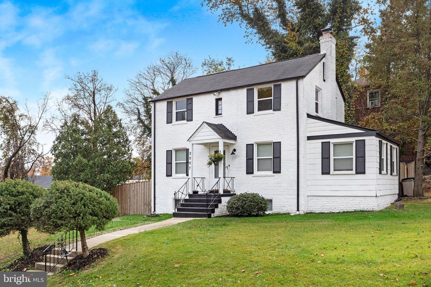 Elegantly renovated in the traditional colonial style, this home spans three spacious levels on a sizable corner lot atop a picturesque hill. The modern kitchen showcases exquisite shaker-style cabinets, granite countertops, and stainless steel appliances. Revel in the warmth of the wood-burning fireplace in the living room, and discover a bonus room with a full bath on the first floor. The upper level features three bedrooms and a generously sized full bath.

Descend to the finished walk-out basement, where a family room, another full bath, and a bonus room await. Each bathroom is gracefully adorned with tile and contemporary fixtures. Outside, a fenced backyard adds to the charm.

Conveniently located, this residence is a short stroll from the West Hyattsville Metro Station, grocery stores, and shopping destinations. Experience the perfect blend of tradition and modernity in this beautifully crafted colonial home.