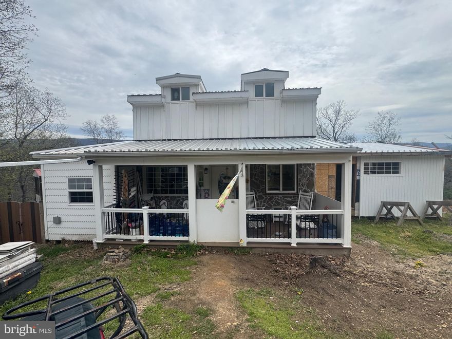 What a great 2 lots that is 10.17 acres waiting for the perfect buyers, this is a unfinished bedroom and bathroom cabin, with views. This property needs a well and septic and to finish what the seller can't do at this time. These lots contain 10.17 acres it is 2 lots. Lot 13 and 14. Its a diamond in the rough, with hunting allowed on your 10 acres. Come take a look at me, very quiet and peaceful. Porch on the front and a back deck on the back with a fenced in backyard.  Picnic area for cook outs, and family get together, this cabin has a loft for extra living space.