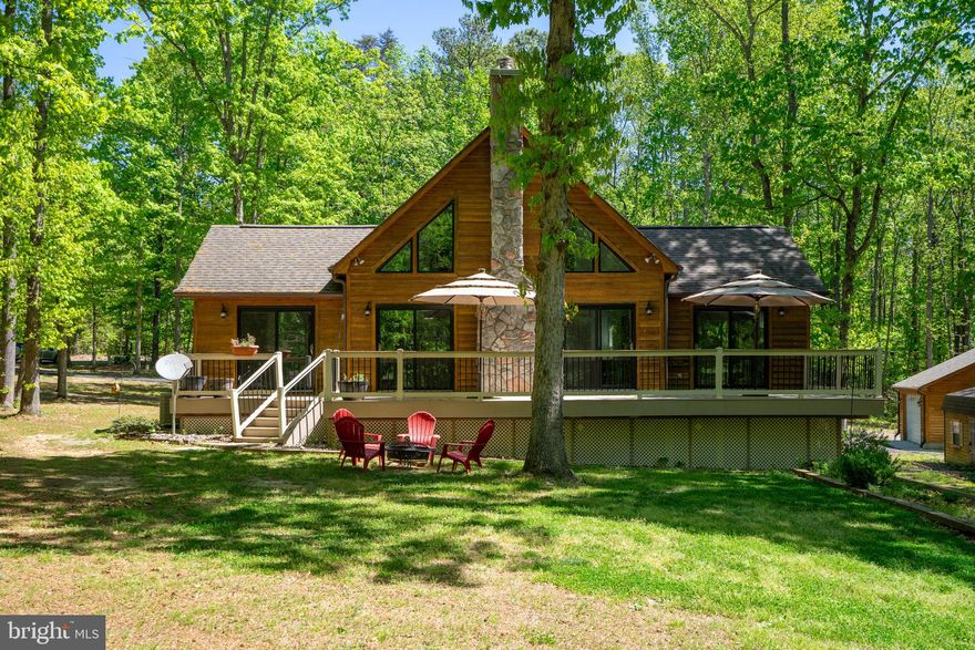 Welcome to 10706 Ropers Run on the highly sought-after south end of the public side of Lake Anna, Virginia. This is the widest and deepest part of the lake, making it ideal for boating, swimming, and full lake enjoyment.

This 3 bedroom, 3 bathroom two-story water access home offers main level living with an open concept design. The bright kitchen features white cabinetry, fresh new paint throughout, and flows seamlessly into the dining area and living room. Large windows and a beautiful fireplace create a warm, inviting space that opens to a spacious back deck overlooking peaceful nature and wildlife.

The primary suite is conveniently located on the main level with a private bath. An additional bedroom and full bathroom are also on the first floor. Upstairs, you will find a bonus living area, an additional bedroom, and full bathroom, offering ideal privacy for guests.

Outside, enjoy a large paved driveway with plenty of room for boats, trailers, and guest parking. The property includes an attached one-car garage, a detached two-car garage, and additional storage sheds for all your lake toys.

Boat slips are available through the HOA common area, which is just steps from the home, providing easy Lake Anna water access. Short-term rentals are allowed, making this a strong investment opportunity. High-speed internet is available, and you are just minutes from restaurants and conveniently closer to Spotsylvania Courthouse and shopping.

Do not miss this opportunity to own on the most desirable side of Lake Anna. Watch the video tour and schedule your private showing today.