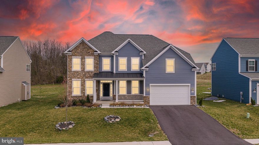 Situated in the sought-after Westfields community, this well-appointed home offers a blend of modern upgrades and functional design. The main level features 9- and 20-foot ceilings, a stone-accented living room (2024), and updated luxury plank vinyl flooring (2024). The kitchen includes a quartz double-depth island, gas stove, pot filler, and contemporary finishes.

A main-level bedroom and full bathroom with dual access provide flexibility for guests or multi-generational living. Washer and dryer are conveniently located on the main level. The finished garage adds additional utility.

The upper level includes a spacious primary suite with double-door entry, cathedral ceiling, dual walk-in closets, and an en-suite bath with double vanities. An additional flex space is suitable for an office or sitting area. Three full bathrooms are located on the second level.

The walk-up basement, finished in 2025, features a full kitchen with induction stove, microwave, dishwasher, and quartz finishes. The lower level also includes two bedrooms with closets (one with full egress window), a full bathroom, a living area, and a dedicated home theater space.

Additional features include a hybrid HVAC system allowing fuel source selection.

Community amenities include a pool, tennis courts, basketball courts, clubhouse, and convenient access to Rockland Elementary School. Located near shopping, dining, Walmart, Wawa, and major commuter routes including I-70.