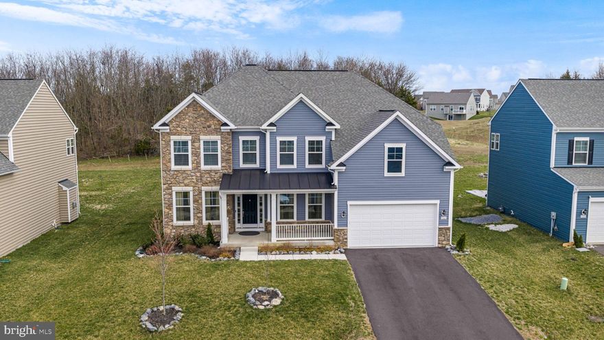 Situated in the sought-after Westfields community, this well-appointed home offers a blend of modern upgrades and functional design. The main level features 9- and 20-foot ceilings, a stone-accented living room (2024), and updated luxury plank vinyl flooring (2024). The kitchen includes a quartz double-depth island, gas stove, pot filler, and contemporary finishes.

A main-level bedroom and full bathroom with dual access provide flexibility for guests or multi-generational living. Washer and dryer are conveniently located on the main level. The finished garage adds additional utility.

The upper level includes a spacious primary suite with double-door entry, cathedral ceiling, dual walk-in closets, and an en-suite bath with double vanities. An additional flex space is suitable for an office or sitting area. Three full bathrooms are located on the second level.

The walk-up basement, finished in 2025, features a full kitchen with induction stove, microwave, dishwasher, and quartz finishes. The lower level also includes two bedrooms with closets (one with full egress window), a full bathroom, a living area, and a dedicated home theater space.

Additional features include a hybrid HVAC system allowing fuel source selection.

Community amenities include a pool, tennis courts, basketball courts, clubhouse, and convenient access to Rockland Elementary School. Located near shopping, dining, Walmart, Wawa, and major commuter routes including I-70.