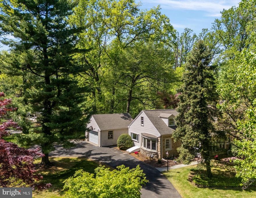SHOWINGS START MAY 3. Discover a rare opportunity in the heart of Rydal! Set on an expansive and beautifully wooded 1.5-acre lot — an incredible find for the area — this 5-bedroom, 4-bathroom raised ranch is designed for ultimate flexibility and comfort. Whether you're seeking space for multi-generational living or dreaming of a luxurious private primary suite, this home has it all.  Freshly painted throughout and thoughtfully updated, the home combines the warmth of an older home with a sleek, modern feel. A charming stone exterior welcomes you into expansive, light-filled spaces, featuring gleaming hardwood floors across the main level. The first floor offers 3 bedrooms and 3 full bathrooms — two of which are en-suite. Every bathroom has been professionally refreshed, with reconditioned grout lending a fresh, polished finish.  Upstairs, the second floor offers a world of its own: 2 additional bedrooms, a library-like hall, a full bath, an extra sink and vanity, and a large, unique — yet tasteful — triangular picture window that floods the suite with natural light. The first and second floor configurations offer the potential for two separate primary suites.  The possibilities here are endless: the home’s flexible layout supports multi-generational living or can easily be separated into three private zones — each with convenient access points, including a direct private entrance to the second floor.  Enjoy cozy evenings by the wood-burning fireplace, morning coffee in the three-season porch, the elegance of original arched doorways, and the perfect blend of original character and modern updates. Storage is exceptional, with capacious closet space throughout the home and a very large, finished basement area — separated from an equally expansive unfinished space for endless storage or workshop opportunities. Outside, the property feels like your own private park, surrounded by mature trees and beds that offer year-round beauty and tranquility. The long, circular driveway offers ample space for your own parking and for guests.  The park-like setting is truly unmatched, offering privacy and space rarely found in the area — yet you're just minutes from top-rated schools like Rydal Elementary and Abington Friends, major hospitals, public transportation, and all the conveniences of Abington Township. 960 Meetinghouse Road is a special combination of careful upgrades and thoughtful preservation of original character. The home and lot together offer a wonderful lifestyle today — or the potential to become a truly breathtaking multi-million-dollar estate. Neighboring one of the most beautiful estates in Montgomery County, this is a rare and exciting opportunity you won’t want to miss!