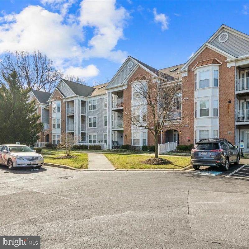 This beautifully maintained condominium is ready for its next loving owner. As you enter, you'll be welcomed by gleaming hardwood floors and an open-concept floor plan. Natural light pours into this home through abundant windows and is accentuated by the cathedral ceilings. A cozy gas fireplace sets the tone for those chilly evening nights or enjoy the private balcony overlooking the forest of your own. Attached to the primary living room you'll find a dining room along with a kitchen equipped with a gas stove and plenty of cabinet space accompanied by a pantry! The oversized primary suite boasts an ensuite full bath and walk-in closet. The second bedroom of this condo connects to a second full bath that also provides entry into the main hallway. The upper level/loft provides a flex space with built-in shelving/desk and a large storage closet. You will not lack storage in this home! Take advantage of all that Annapolis has to offer while being conveniently located to all major commuting routes. Your new home awaits you!