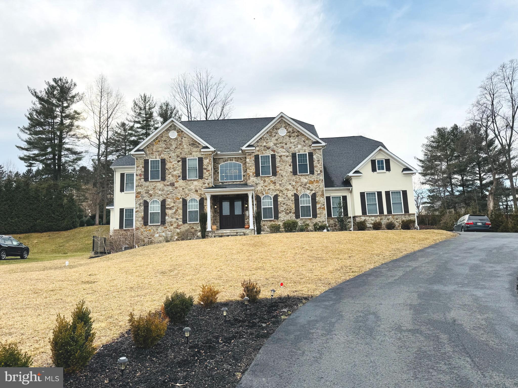 This colonial home is a true masterpiece, blending modern luxury with timeless elegance. Its spacious interior, flooded with natural light, provides an open-concept design perfect for both intimate family gatherings and large-scale entertaining. The home's striking architectural ceiling details, such as 2 story barrel ceiling with trim in the great room, groin vault ceiling in the dining room, coffered ceiling in the kitchen, and boxed tray ceiling in the living room, add a touch of grandeur to every space.
The gourmet kitchen is a chef's dream, featuring top-of-the-line appliances, an expansive island, and exquisite Maple Cabinets with soft-close doors and drawers, as well as practical roll-out trays for easy access. Under-cabinet lighting and a pantry light activated by the door provide both functionality and ambiance.
For those who love to entertain, the home offers a gracious dining room for more formal occasions, and the spacious family room, complete with a cozy fireplace, is the heart of the home, perfect for casual gatherings. The conservatory and remote-controlled blinds throughout the main level add to the home's luxurious and functional appeal.
Outside, the serene backyard is an oasis, with a patio that overlooks beautiful views, a firepit, and an ideal space for relaxation and enjoyment. The property offers a total of seven bedrooms and seven full baths, ensuring privacy and comfort for all. The primary suite is a sanctuary in itself, with a spa-like bath and expansive closet space. Each of the four additional upper-level bedrooms has its own ensuite bath, offering ultimate convenience.
The lower level is designed for entertaining, with a large recreation room, an additional bedroom suite, a state-of-the-art home theater with tiered seating, and a fitness/game room that completes this stunning residence. This home truly offers the perfect combination of luxury, functionality, and style, making it a rare find in an extraordinary setting.