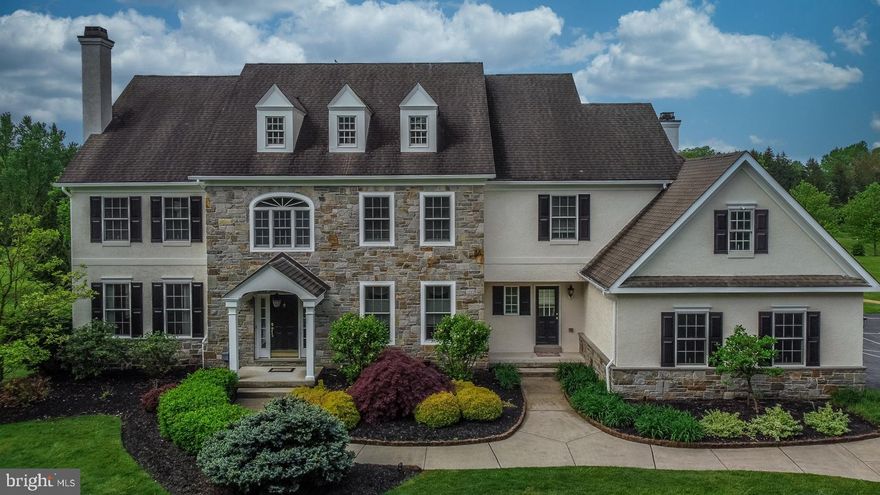 Welcome to this stunning executive home in sought after Harleysville, where luxury meets tranquility on beautifully manicured 2 acres. Every detail has been meticulously maintained and updated throughout this expansive 5-bedroom, 4-full, and 2-half-bath residence. Step into the grand foyer adorned with crown molding and wainscoting, leading to the formal living room featuring a gas fireplace, and the large, elegant formal dining room boasting a tray ceiling and both offering additional wainscoting. The dining room seamlessly connects to the gourmet kitchen via the Butler’s pantry, showcasing stainless steel appliances, a gas stove, double oven, granite counters, and a spacious island that comfortably seats five. The kitchen includes a lovely breakfast area with plenty of room for all of your guests. Adjacent is the two-story family room with vaulted ceiling, floor-to-ceiling windows offering spectacular light, and a cozy wood-burning fireplace with a stone mantle. Slide open the glass doors from the breakfast area to the patio adorned with brick pavers, providing ample space for entertaining, including a fire pit and a sprawling private backyard. This expansive backyard is graced with  both a full sprinkler system as well as an invisible dog fence. A formal office with French doors and cherry wood built-in bookcases overlooks the serene backyard. Completing the first floor are a three-car garage, mudroom with cubbies, an additional informal powder room, and additional access to the front exterior. Ascend the formal front staircase to discover double doors leading to a tranquil sitting room and the formal master bedroom with a double tray ceiling, recessed lighting, and a grand walk-in closet. Indulge in the en suite formal bathroom featuring a Jacuzzi tub, oversized two-person shower, and his and hers separate sink areas. Three additional large bedrooms await on the second floor, including a princess suite with its own full bath, while two bedrooms share a Jack and Jill bathroom. A sprawling laundry room with built-ins and a built-in desk area perfect for a home office or study space complete the second floor. Descend the back staircase to the fully finished walkout basement boasting a wet bar, huge entertaining room, an additional office space, a full bathroom, and ample storage. Thoughtfully added solar panels not only cover the cost of electricity but also generate income for the seller. A whole house generator ensures comfort no matter the weather.  Conveniently located near the turnpike, major routes, and shopping amenities including the new Whole Foods and Target, this home truly has it all.