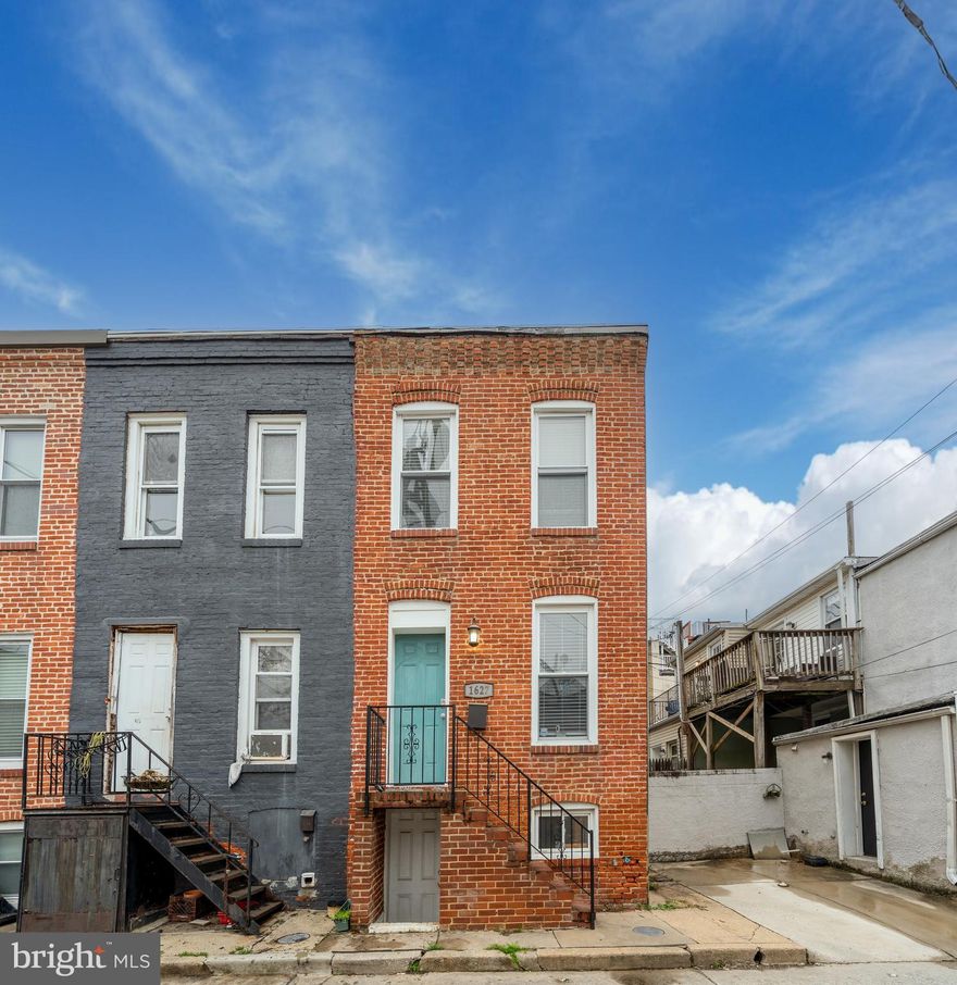 Welcome to 1627 Olive Street, a quaint 2 bedroom end-unit rowhome nestled in the heart of Federal Hill. As you make your way inside, you'll be greeted by hardwood floors and exposed brick walls, a signature charm of Baltimore homes. The updated kitchen features granite countertops, stainless steel appliances, and a stylish tile backsplash, making it perfect for culinary enthusiasts. Just beyond, a private deck provides an ideal space for morning coffee or evening relaxation. Upstairs, you’ll find two bedrooms and a fully renovated bathroom. The lower level offers a versatile space that can serve as an additional living room or home office. Experience the best of city living with the charm of historic architecture at 1627 Olive Street.