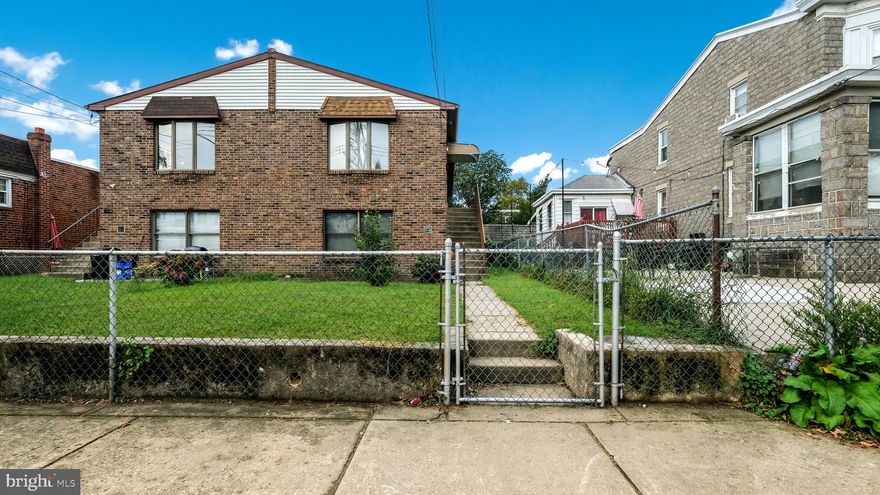 Welcome to this Holmesburg twin raised ranch located on a quiet two-way street with ample on-street parking. The home features a gated front yard with patio and a fenced yard, creating both privacy and charm. The main level offers a spacious living room with vaulted ceilings, a dining area, and a modern kitchen with a breakfast bar, built-in dishwasher, plenty of cabinet space, and newer appliances including a garbage disposal. This level also includes two bedrooms, a full hall bathroom, and a main bedroom with ceiling fan, two closets, and direct access to the bathroom. The lower level provides incredible flexibility with a family room that can also be used as a third bedroom or office, along with a second kitchen, bathroom, storage closets, washer and dryer hookup, and interior access to a one-car garage with a newer garage door and exterior driveway. With the potential for multigenerational living, the layout offers both comfort and practicality. Additional highlights include central air conditioning, convenient access to transportation, shopping, and major roadways, and a well-designed floor plan that maximizes space and livability.