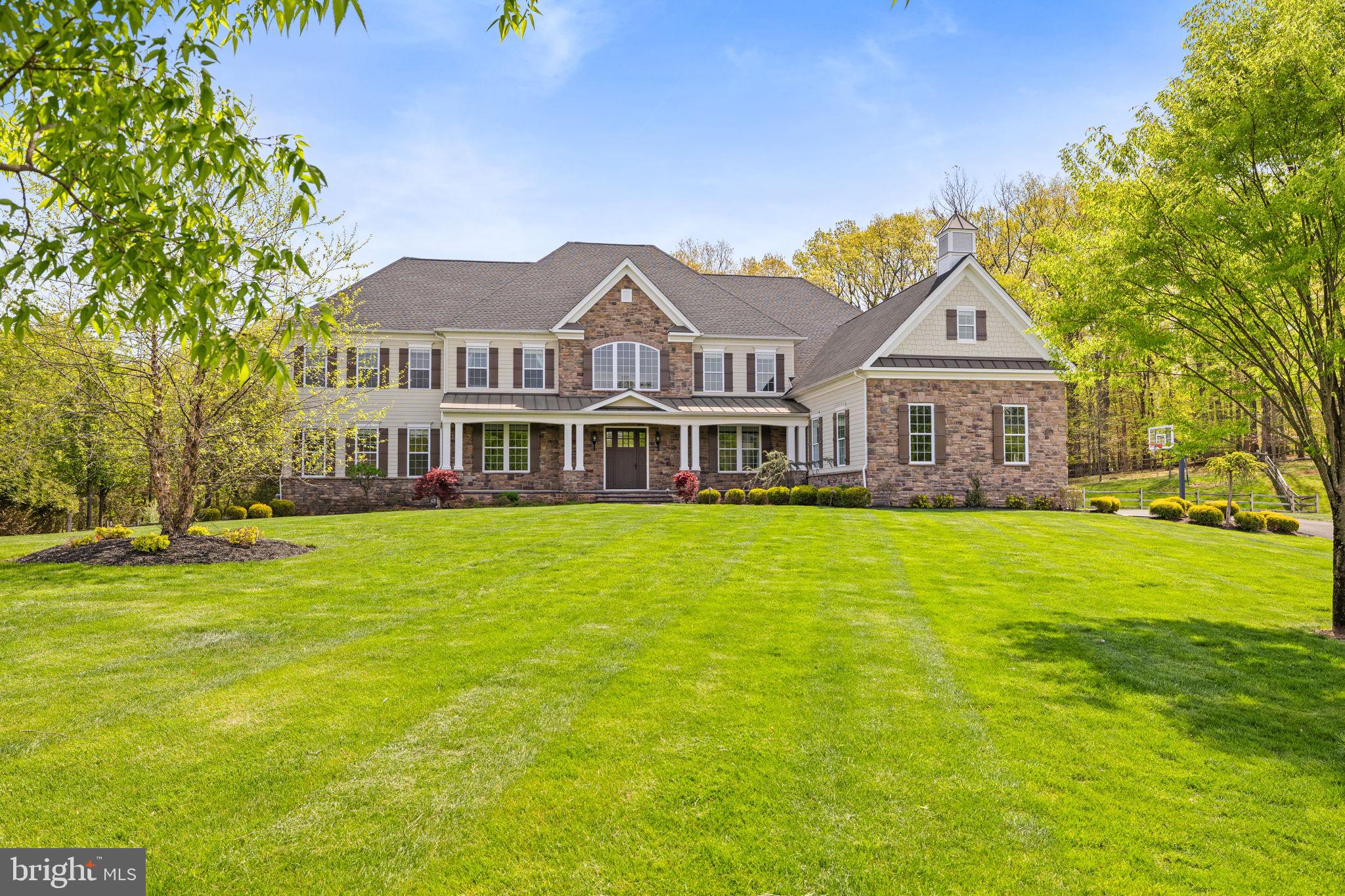 Welcome to Dutchess Farm Estates, where luxury living reaches its pinnacle! Nestled in highly-coveted Upper Makefield, this spectacular 5 bedroom, 5.5 bath offers an unparalleled experience in refined living. From the moment you arrive, you'll be greeted by picturesque landscaping and an enchanting curb appeal that sets the stage for this move-in ready home. Step inside and be greeted by a grand two-story entrance foyer, adorned with a curved staircase and striking hardwood floors which flow seamlessly throughout most of the main level. Every inch of this home has been thoughtfully designed with meticulous attention to detail. The neutral decor, intricate moldings, wainscoting, and abundant windows bathe this center hall in natural light and make this home so special. An elegant dining room flanks one side of the home’s entry way and features a bay window overlooking the picturesque front yard and connects to the kitchen area. Also on first floor is formal living room that connects to a spacious conservatory filed with natural light and a spacious office that leads to a fabulous screened loggia adorned with a floor-to-ceiling stone wall with a gas fireplace and flagstone flooring. Across the rear of the homes is a gourmet kitchen which boasts a large island with counter seating, stainless steel appliances, and a breakfast area. Ideal for entertaining and open to the kitchen is generous yet cozy gathering room with a floor-to-ceiling stone gas fireplace with raised hearth; a perfect gathering spot for family and friends. Down the hallway from the kitchen is a very large walk-in pantry, a half bath and access to a 4-car garage. Ascend to the second level from the back staircase and discover the spectacular master bedroom suite, an oasis of tranquility with a spacious sitting room, expansive walk-in closet, laundry room and a luxurious bath, offering the ultimate retreat from the world. Four additional bedrooms, each with its own private bathroom, provide comfort and privacy for family members and guests alike. The lower level of this extraordinary home could be an entertainer's dream, and features a full bath and a sprawling walkout basement. Whether you're a hobbyist, fitness enthusiast, or lover of games and sports, this versatile space offers endless possibilities for enjoyment. Located within the award-winning Council Rock School District, this property combines luxury, comfort, and convenience in one remarkable package. Don't miss out on this special opportunity to call this splendid property your own. Embrace the lifestyle you deserve—schedule your viewing today and embark on a journey towards unparalleled luxury living at Dutchess Farm Estates!