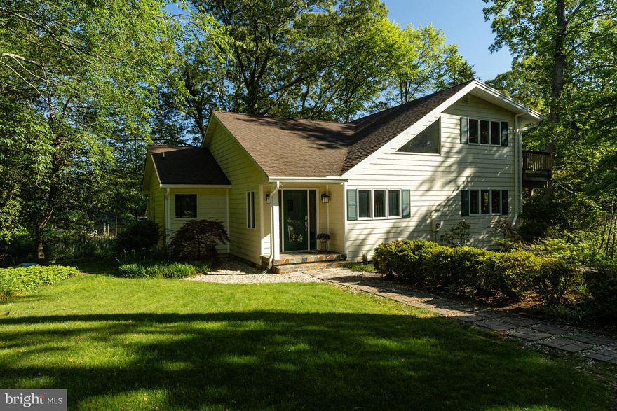 If you've been searching for a private, waterfront retreat with acreage in a serene, natural setting—your search ends here! Nestled at the end of a quiet cul-de-sac, this exceptional 2.43-acre property is accented with mature hardwoods and holly trees, and features elegant landscape lighting that lines the driveway and retaining wall. With 140 feet of water frontage on scenic Sam Abell Cove, the property also borders the tranquil Myrtle State Park.

This peaceful cove is also perfect for kayaking and paddleboarding, offering calm waters and stunning views. As you explore, you may spot majestic bald eagles, graceful egrets, the stately blue herons and ospreys soaring overhead or nesting nearby. In the evenings, unwind on the screened-in porch, listening to the sounds of nature and views of sunsets over the Cuckold Creek.  Enjoy crabbing or fishing right from your private pier, or take a short boat ride  popular waterfront dining on Solomon's Island. 

This home underwent a top-to-bottom custom renovation in 2007, including more than 400 square feet of additional living space. High-end upgrades include Andersen casement windows & sliding doors, solid core wood interior doors, custom moldings, hardwood flooring, designer lighting, updated bathrooms, a gourmet kitchen, Hardie Plank siding, and a newer roof.

The main level features a spacious great room with vaulted, beamed ceilings, gleaming hardwood floors  that open to the cozy  screened porch. The gourmet kitchen is a chef’s dream, boasting Wolf gas cooktop with grill, double ovens, dual dishwasher drawers, a wine/beer fridge, beautiful soapstone countertops, a butcher block island, and custom cherry cabinetry—including a walk-in butler’s pantry with coffee bar. The adjacent dining area opens onto a sun deck, perfect for grilling and entertaining.
 
The main level also includes a primary suite with a walk-in closet and custom bathroom with cherry cabinets, granite counters, tile floors, and a spacious dual-head shower. A second bedroom and full bath with shower complete the first floor. Upstairs are two generously sized bedrooms with a Jack-and-Jill bathroom. The larger upstairs bedroom features sliding glass doors that open to a private deck with a peaceful picture, where cattails sway in the breeze and the sounds of nature surround you—perfect for soaking in the quiet, rustic beauty of the landscape.

The  basement includes laundry facilities, a utility sink, built-in storage, and mechanicals. It also offers a finished flex space  perfect for a  workout area, recreation zone, or craft room.  Loads of storage throughout!'

Enjoy the gentle slope to the 80 foot walkway leading to the 85-foot pier, featuring a renovated 12,500 lb boat lift, with second slip

Oversized  4 car garage featuring a structural I-beam for possible car lift, a spacious attic for additional storage, and a whole-house attic fan. Recently updated with a new roof (April 2025). Includes an attached shed for convenient outdoor storage. A second garden shed is located within the fenced vegetable garden.