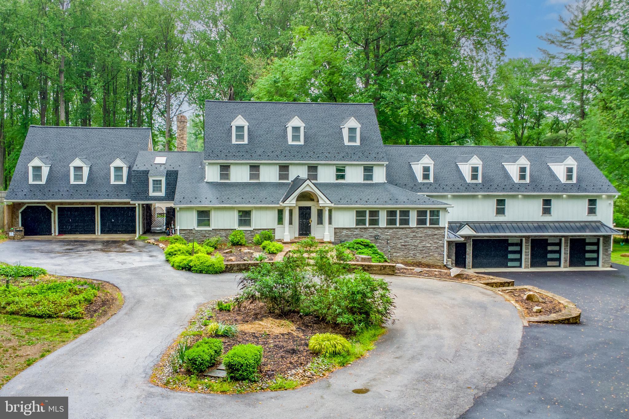 Welcome to 16 Indian Way, an exceptional 7-bedroom, 5-full and 3-half-bath custom home tucked away on a private cul-de-sac in beautiful Malvern. Thoughtfully designed and extensively upgraded, this sprawling residence offers luxurious comfort, abundant space, and a resort-style backyard perfect for everyday living and unforgettable entertaining. A wide circular driveway welcomes you to the stately front entrance. Inside, you're greeted by a grand foyer with gleaming hardwood floors, elegant columns, and a custom coat closet. To the left is a spacious game room with semi-vaulted ceilings, hardwood flooring, built-in cabinetry, and a wet bar. To the right, the formal dining room features hardwood floors, a stunning chandelier, and flows into a bright office enclosed by glass doors, with vaulted ceiling and expansive windows. Down the hall, marble flooring leads you past a powder room, storage closet, and access to a large walk-in pantry. The main living room showcases hardwood floors, a wood-burning fireplace, crown molding, and built-ins, with direct access to the backyard oasis. The chef’s kitchen features tile flooring, two oversized islands—one with a sink, the other with a gas cooktop—granite countertops, maple cabinetry, a double sink, custom wine closet, and a double-sided propane fireplace. A passthrough opens into the sunroom, where vaulted and coffered ceilings, skylights, ceiling fans, a powder room, and a sliding door to the deck make this space perfect for relaxing. Step outside to your own private retreat. The fenced backyard includes a composite deck, a one-year-old in-ground pool, koi pond with fish, a pavilion with outdoor kitchen, firepit, and a shed with an attached chicken coop—ideal for entertaining or quiet outdoor enjoyment. Back inside,the kitchen leads into a stunning recent addition. The vaulted family room offers hardwood floors, large windows, and a double-sided fireplace with another slider to the deck. A dedicated theater room with millwork ceiling, built-in speakers and cabinetry, and authentic red theater seating adds a touch of luxury. The main-level primary suite is a private sanctuary with a semi-vaulted ceiling, natural light from arched windows, and a hidden safe room. The spa-like en-suite bathroom includes marble floors and counters, a center island, dual water closets, and a luxurious walk-in shower with rain head and handheld spray. The oversized walk-in closet offers custom cabinetry, a glass display island, and a mirrored wall. Upstairs, the original primary suite features hardwood floors, built-ins, walk-in closet, and a marble en-suite bath with vaulted ceiling, chandelier, skylight, soaking tub, dual vanities, fireplace, and two water closets. Two walk-in closets lead to a separate dressing room with skylight and custom cabinetry. Also on this level: a full hall bath, laundry room, and two carpeted bedrooms with ceiling fans and open closets—ideal for children or guests. The third floor includes a vaulted sitting room, two carpeted bedrooms with semi-vaulted ceilings, and a full bath with step-in shower. Attached to the home is a full in-law suite complete with carpeted living and dining areas, tiled kitchen with granite counters, propane cooktop, and an upper loft. The bedroom includes a walk-in closet and a bathroom across the hall, with a lighted mirror and walk-in shower. Below, the pool bathhouse features a full bathroom, dressing room, powder room, and connects to the 2-car garage. The finished lower level offers hardwood floors across three rooms—currently used as a playroom, guest room, and flex space—plus storage and a utility room with two heaters and instant hot water. Conveniently located near shopping, restaurants, and more—this one-of-a-kind home has it all. Don’t miss your chance to make it yours!
