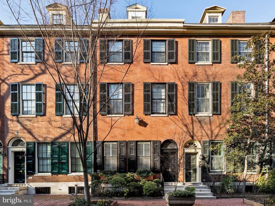 On a quiet, tree-lined block in Philadelphia’s storied Washington Square West, 1013 Clinton Street offers a rare combination of architectural scale and thoughtful interior design. Spanning over 6,000 square feet across five levels, this 20-foot-wide residence was masterfully reimagined by Widell + Boschetti, pairing grand proportions with refined, livable interiors.

The first level unfolds with an open living and dining rooms both anchored by a gas fireplace and framed by French style doors leading to a private courtyard patio providing an elegant extension of the living space. A guest powder room sits just off the main entertaining areas, while the eat-in gourmet kitchen features a walk-in pantry and an additional half bath.

Upstairs, the second floor is designed for everyday living and retreat. A warm family room with built-ins and fireplace includes a cleverly concealed full bath, allowing the space to function as a guest suite when needed. The primary suite occupies the remainder of the level, defined by soaring ceilings, a fireplace, and a generous dressing room with two walk-in closets and a washer/dryer. The spa-like bath is finished in marble with heated floors, double vanity, walk-in shower, and freestanding soaking tub.

The third floor offers another bedroom suite with dressing room and private bath, along with two additional bedrooms and a hall bathroom. Above, the fourth level provides a spacious bedroom suite with a glass-enclosed shower and single-vanity bath—ideal for guests, an au pair, or a quiet home office retreat.

A finished lower level expands the living space with a large playroom, den, or media room, along with a laundry room and ample storage.

Completing the offering, two parking spaces are available to lease just one block away, an uncommon convenience in this historic neighborhood.

A home of remarkable width, scale, and design pedigree, 1013 Clinton Street blends classic Philadelphia architecture with elevated modern living in one of the city’s most coveted residential neighborhoods.