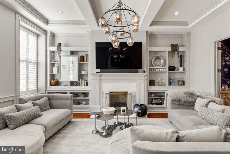 On a quiet, tree-lined block in Philadelphia’s storied Washington Square West, 1013 Clinton Street offers a rare combination of architectural scale and thoughtful interior design. Spanning over 6,000 square feet across five levels, this 20-foot-wide residence was masterfully reimagined by Widell + Boschetti, pairing grand proportions with refined, livable interiors.

The first level unfolds with an open living and dining rooms both anchored by a gas fireplace and framed by French style doors leading to a private courtyard patio providing an elegant extension of the living space. A guest powder room sits just off the main entertaining areas, while the eat-in gourmet kitchen features a walk-in pantry and an additional half bath.

Upstairs, the second floor is designed for everyday living and retreat. A warm family room with built-ins and fireplace includes a cleverly concealed full bath, allowing the space to function as a guest suite when needed. The primary suite occupies the remainder of the level, defined by soaring ceilings, a fireplace, and a generous dressing room with two walk-in closets and a washer/dryer. The spa-like bath is finished in marble with heated floors, double vanity, walk-in shower, and freestanding soaking tub.

The third floor offers another bedroom suite with dressing room and private bath, along with two additional bedrooms and a hall bathroom. Above, the fourth level provides a spacious bedroom suite with a glass-enclosed shower and single-vanity bath—ideal for guests, an au pair, or a quiet home office retreat.

A finished lower level expands the living space with a large playroom, den, or media room, along with a laundry room and ample storage.

Completing the offering, two parking spaces are available to lease just one block away, an uncommon convenience in this historic neighborhood.

A home of remarkable width, scale, and design pedigree, 1013 Clinton Street blends classic Philadelphia architecture with elevated modern living in one of the city’s most coveted residential neighborhoods. The Seller will provide 1-year prepaid parking for one of the spaces.