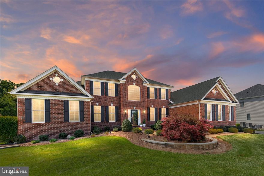 **Listed at Appraised Value**OPEN SAT 5/16 & SUN 5/17 2-4PM
Tucked away on a rare and private .92 acre lot backing to a serene conservation area, this exceptional Cumberland Williamsburg model offers 6,582 finished square feet of refined living in the prestigious gated community of Dominion Valley Country Club. From the moment you arrive, the stately curb appeal, side-load three-car garage, extended driveway, and professionally landscaped grounds set the tone for what awaits inside. A dramatic two-story foyer with gleaming hardwood floors, crown molding, and elegant shadowbox trim welcomes you into the home. Designed for both everyday living and grand entertaining, the open concept layout features a stunning gourmet kitchen complete with updated quartz countertops, subway tile backsplash, upgraded maple cabinetry with glass accents and end panels, gas cooktop, double wall ovens, French door refrigerator, spacious island, pantry, and hardwood flooring. The adjoining two-story family room is the true heart of the home, showcasing a soaring vaulted ceiling, wall of windows overlooking the private backyard, built-ins, gas fireplace, surround sound speakers, plantation shutters, and a secondary rear staircase. Just beyond, the light-filled solarium with vaulted ceiling and tile flooring opens to the expansive Trex deck, creating the perfect indoor-outdoor flow for entertaining or simply enjoying the peaceful wooded views. Set on one of the largest and most private lots in Dominion Valley, the backyard offers endless possibilities to create the outdoor retreat of your dreams. Whether you envision a custom pool, outdoor kitchen, firepit lounge, sports court, or a resort-style backyard oasis, this expansive homesite provides the perfect canvas to bring your vision to life while enjoying the privacy and beauty of the surrounding conservation area. The luxurious main-level primary suite offers a private retreat with hardwood flooring, double-door entry, sitting area framed by decorative columns, dual walk-in closets, and a spa-inspired bath featuring marble countertops, dual vanities, soaking tub, oversized shower with bench seating, vaulted ceiling, and plantation shutters. Upstairs, plush new carpeting extends throughout the spacious secondary bedrooms, including a private princess suite with en suite bath and walk-in closet, two additional bedrooms connected by a Jack-and-Jill bath, a spacious loft area with recessed lighting and crown molding, and a finished upper-level storage room with hardwood flooring. The finished walk-out lower level offers incredible versatility with 9-foot ceilings, abundant daylight windows, a sprawling recreation room with rough-in for a future wet bar, a den, full bath, workshop, and oversized storage area. Outside, the backyard continues with an expansive paver patio, fountain, deck speakers, irrigation system, and mature landscaping designed for year-round enjoyment and privacy. Additional upgrades include Hunter Douglas plantation shutters and silhouette shades, custom window treatments, new Zone 1 HVAC system installed in 2025, and new garage door openers. Living in Dominion Valley Country Club means enjoying an unmatched lifestyle with access to an Arnold Palmer Signature golf course, renovated clubhouse, state-of-the-art fitness center, indoor and outdoor pools, tennis and pickleball courts, scenic walking trails, and highly rated schools located within the community. Conveniently located near shopping, dining, wineries, breweries, and major commuter routes. Rare opportunities like this do not come along often. Schedule your private tour today and experience the lifestyle that makes Dominion Valley Country Club one of Northern Virginia’s most sought-after communities.