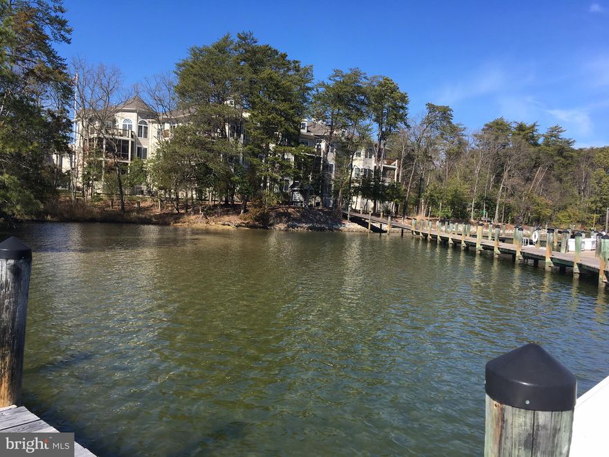Enjoy incomparable waterfront living with this top floor condominium in the Harbor View point location building in Solomons Landing. This unit features an elegant entry to an open floor plan with wood floors and water views from the main living area and primary suite which both access the deck with retractable awning overlooking the water and marina. Your boat slip is visible from the unit and easily accessible for boating enjoyment. The kitchen is nicely appointed with attractive on trend white cabinetry, granite prep surfaces, pantry, and breakfast area, opening to a dining room and living room area, a perfect entertaining space. The Solomons Landing amenities complete the perfect waterfront lifestyle convenient to charming Solomons.